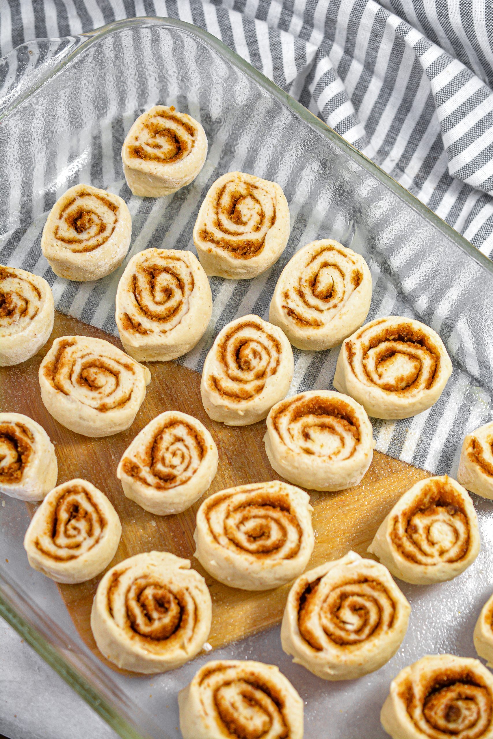 Place the cinnamon rolls flat side down into a well-greased 9x13 baking dish.