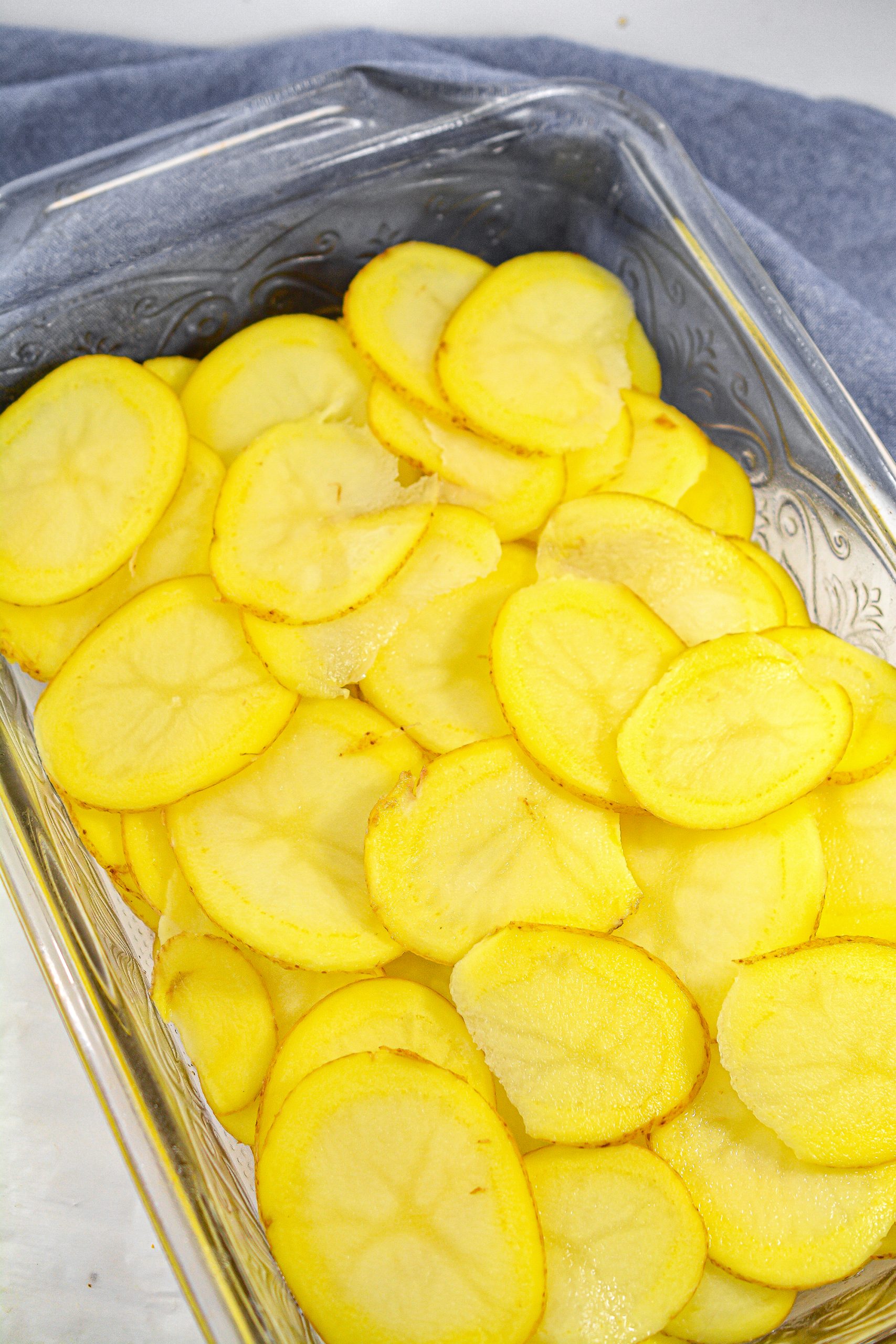 Layer the potatoes on the bottom of a well-greased 9x13 baking dish.