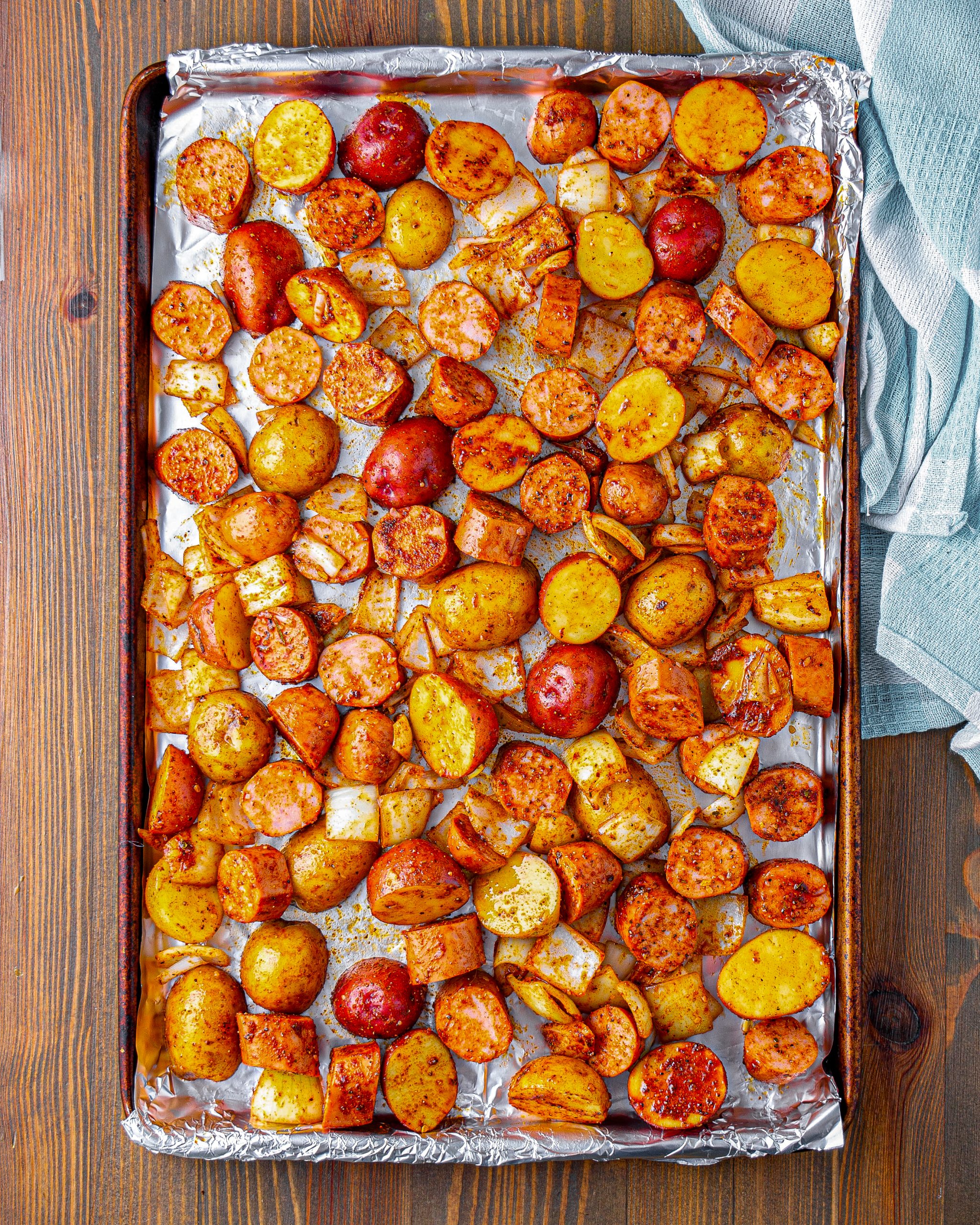 Pour this out onto the sheet pan and spread out the sausage and potatoes evenly.