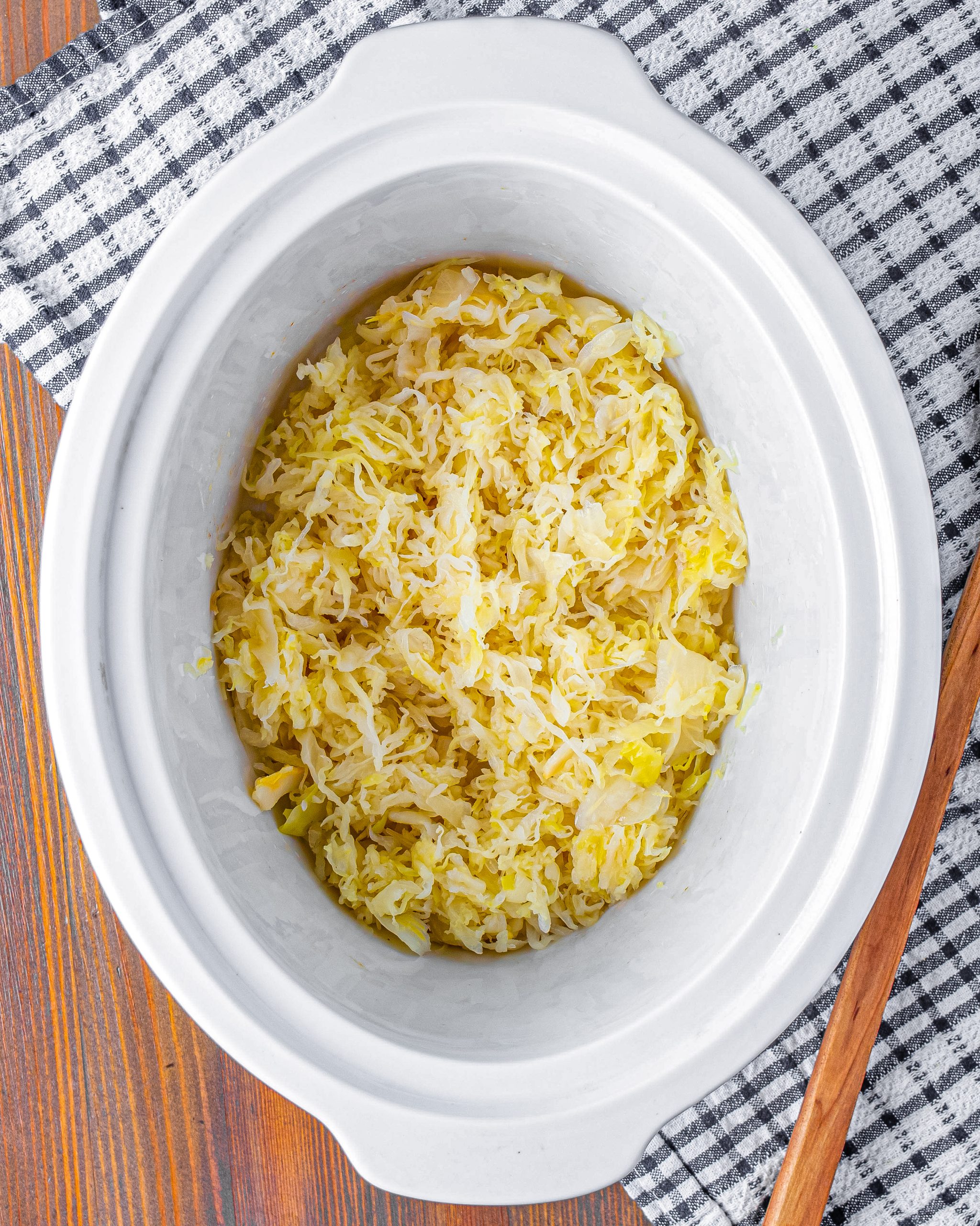 Place the sauerkraut into the bottom of the crockpot.