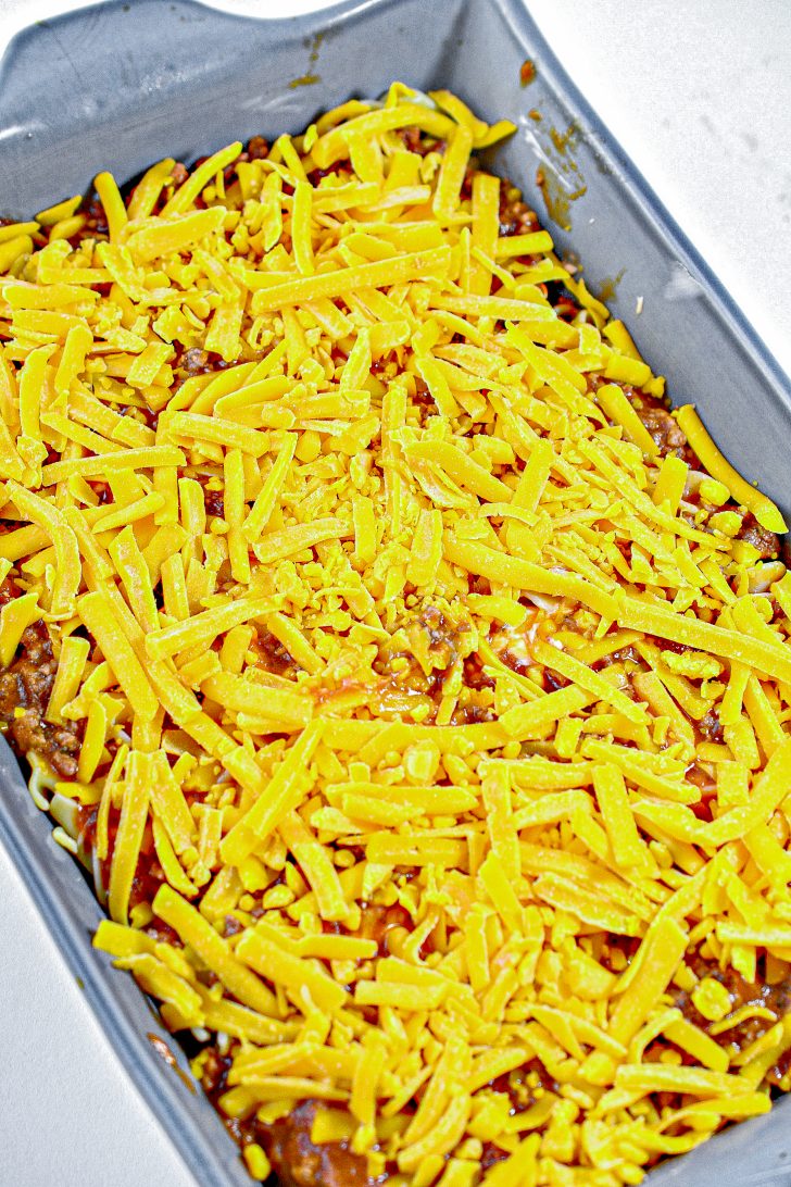Sprinkle 1 ½ cup of cheddar cheese on the top of the casserole.