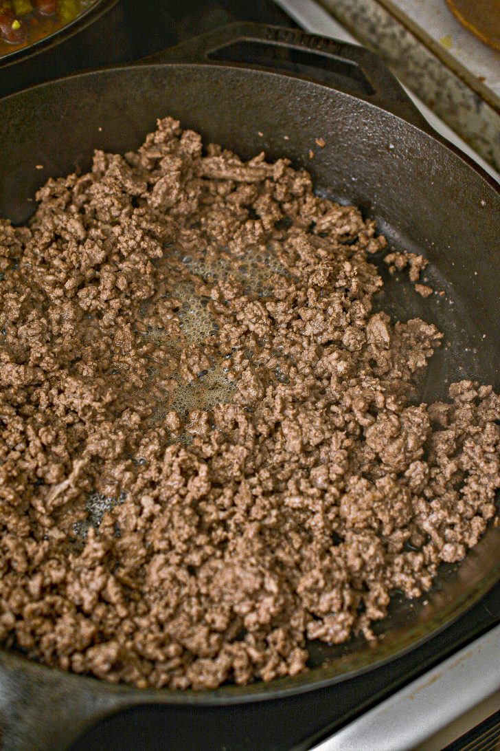 In a skillet over medium-high heat on the stove, saute the ground beef until it is completely browned. 
