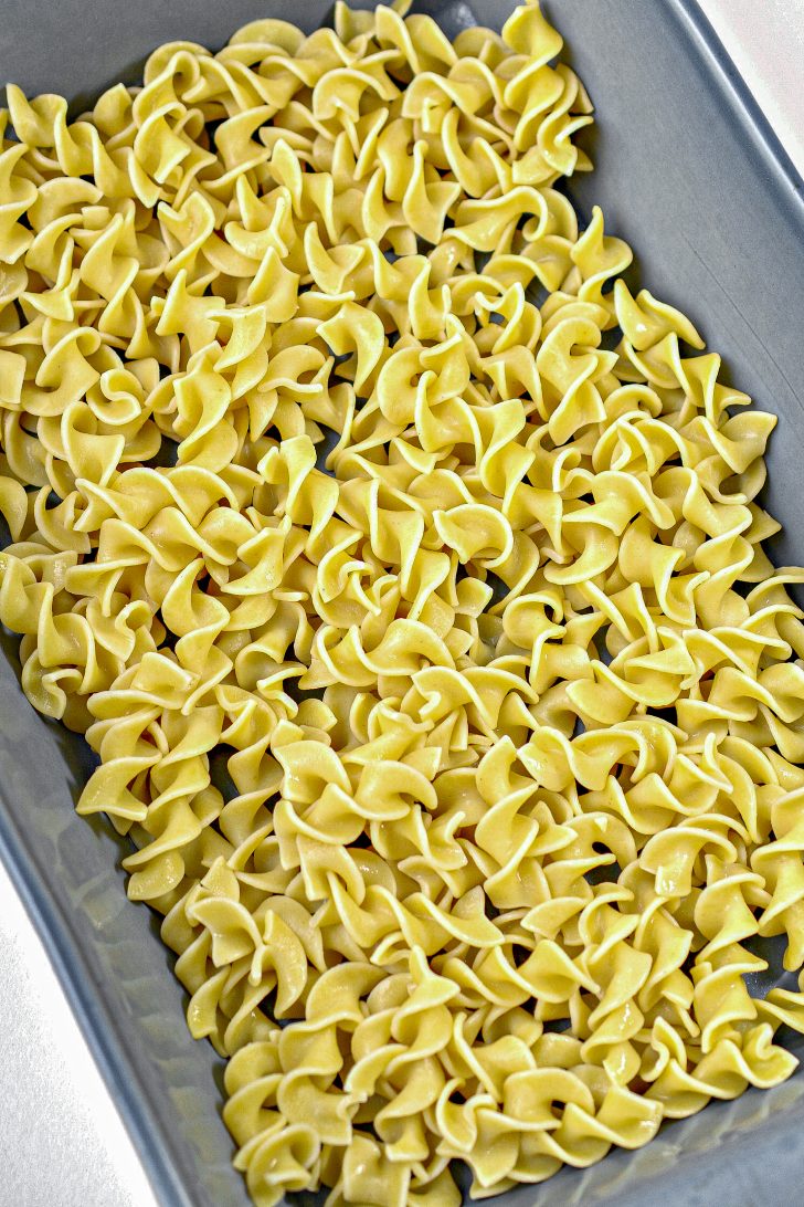 Place ½ of the egg noodles in an even layer on the bottom of a greased 9x13 baking dish.