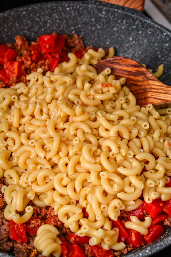 Mix in the elbow macaroni and salt and pepper to taste.