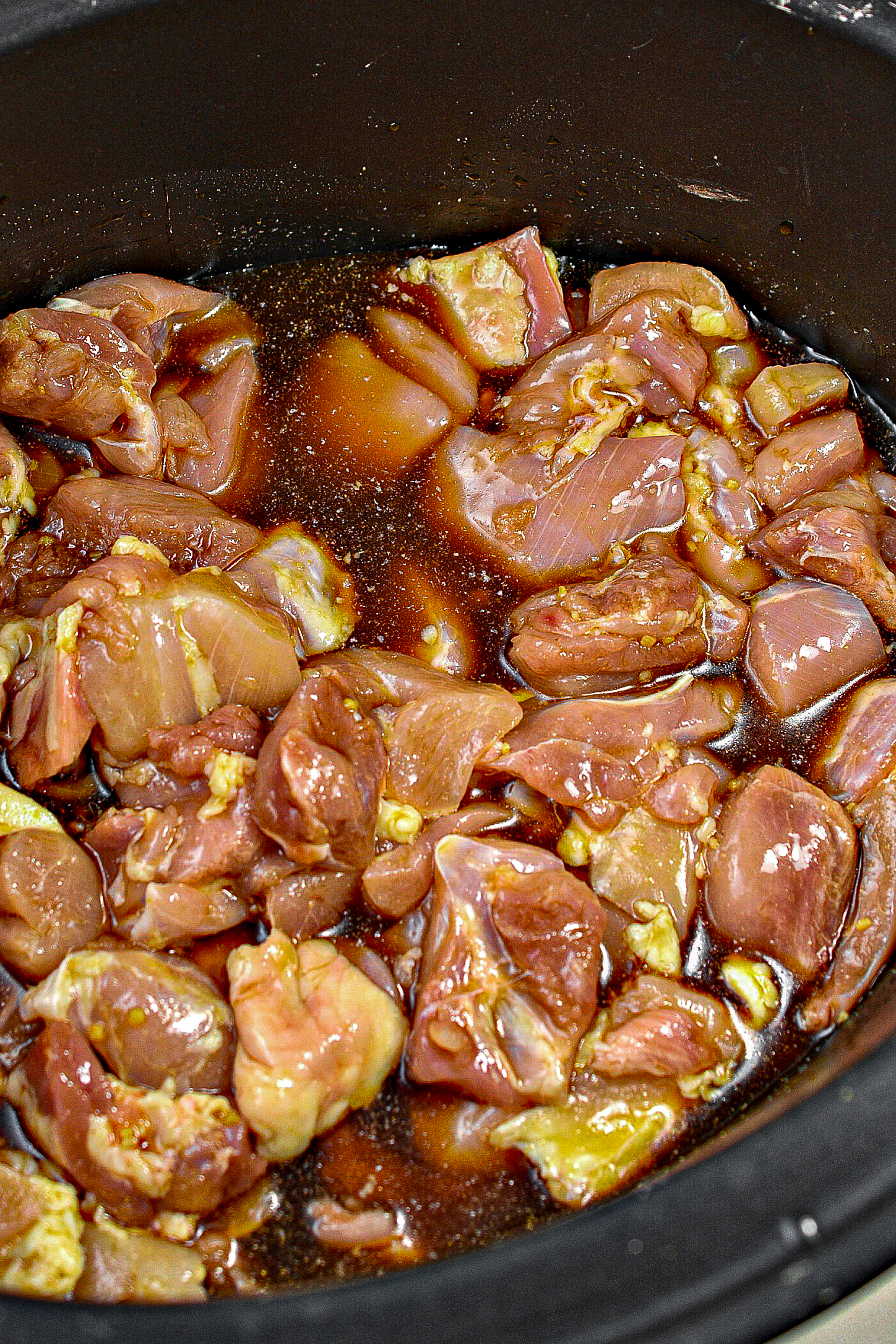 Cut the chicken thighs into bite-sized pieces and add them to the slow cooker. Toss to coat in the sauce.