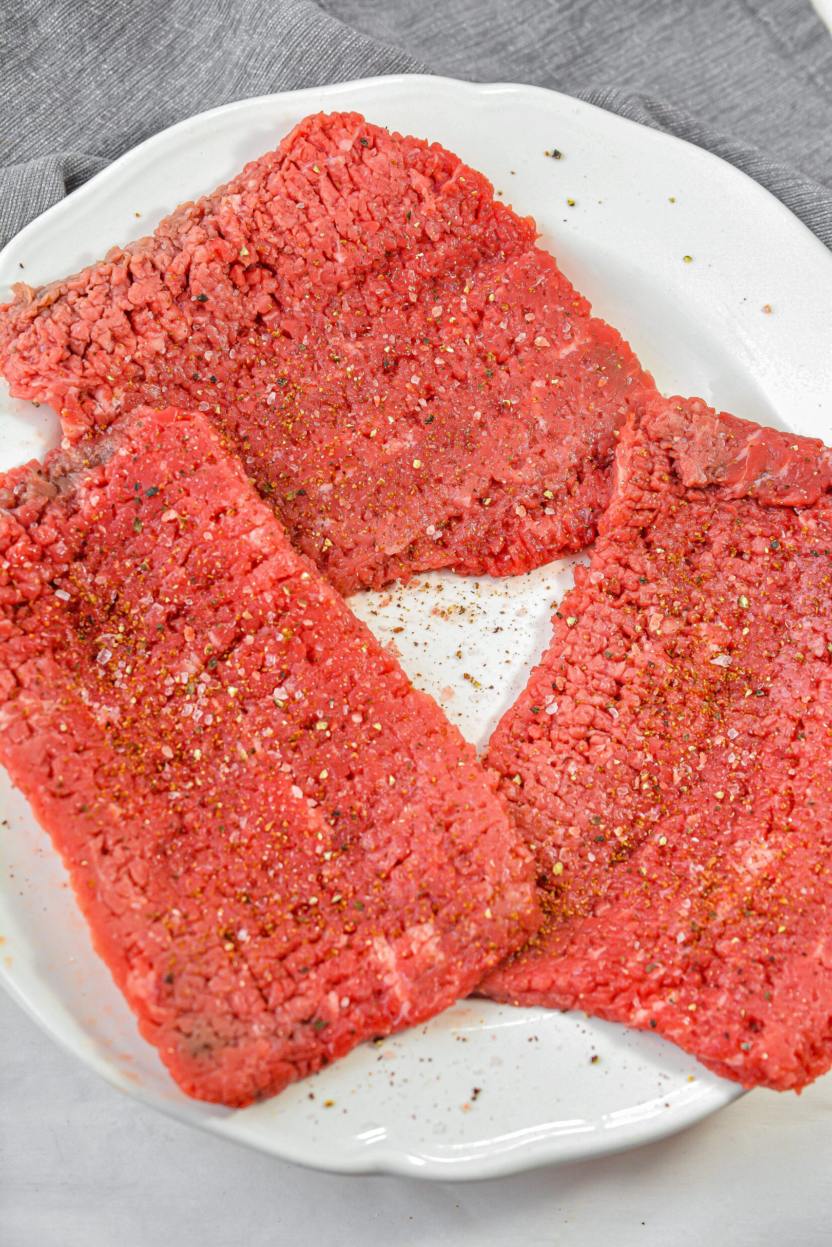 Season the cube steak on both sides with the cajun seasoning as well as salt and pepper to taste.