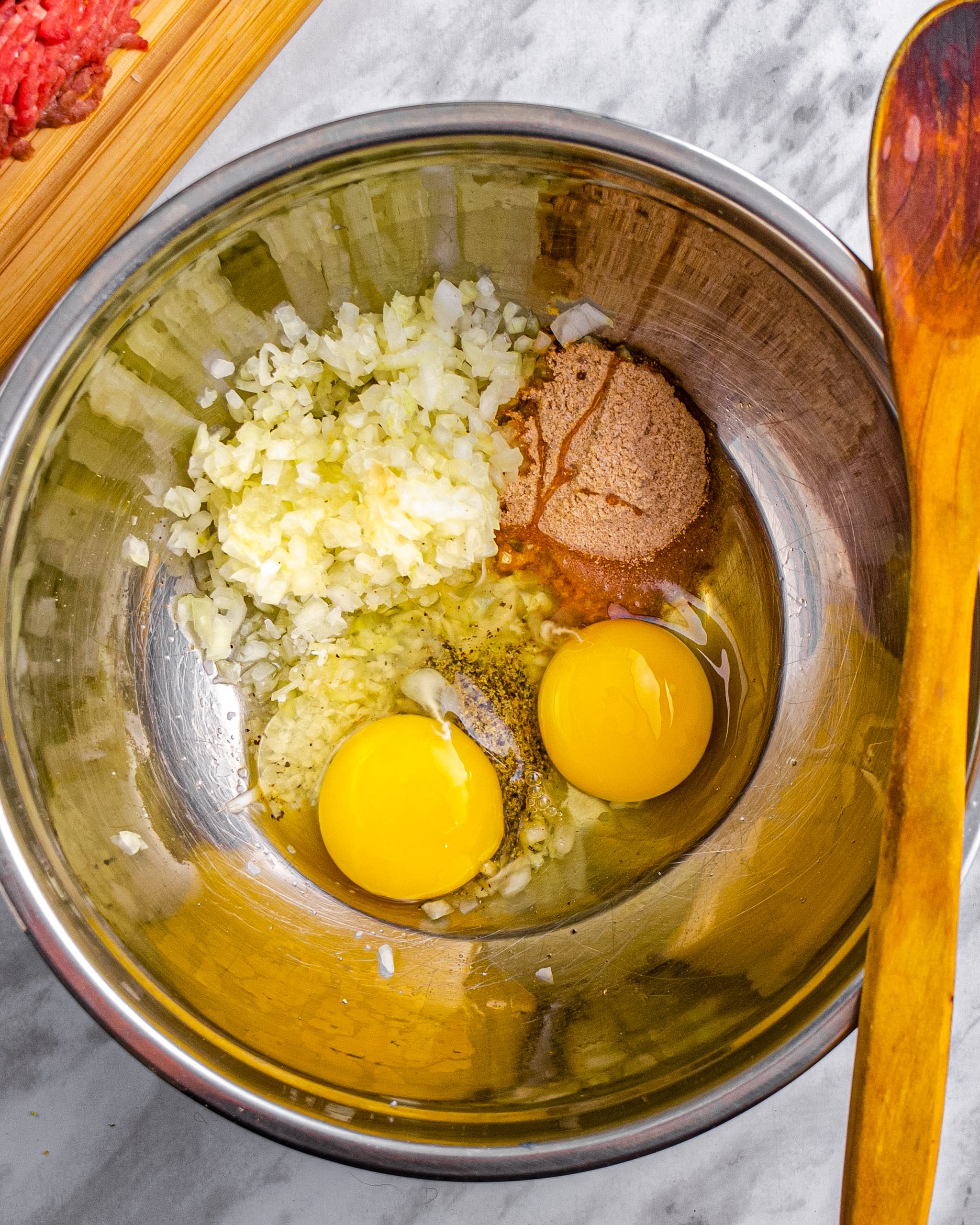Mix together the eggs, onion, bouillon powder, and salt and pepper to taste in a bowl.