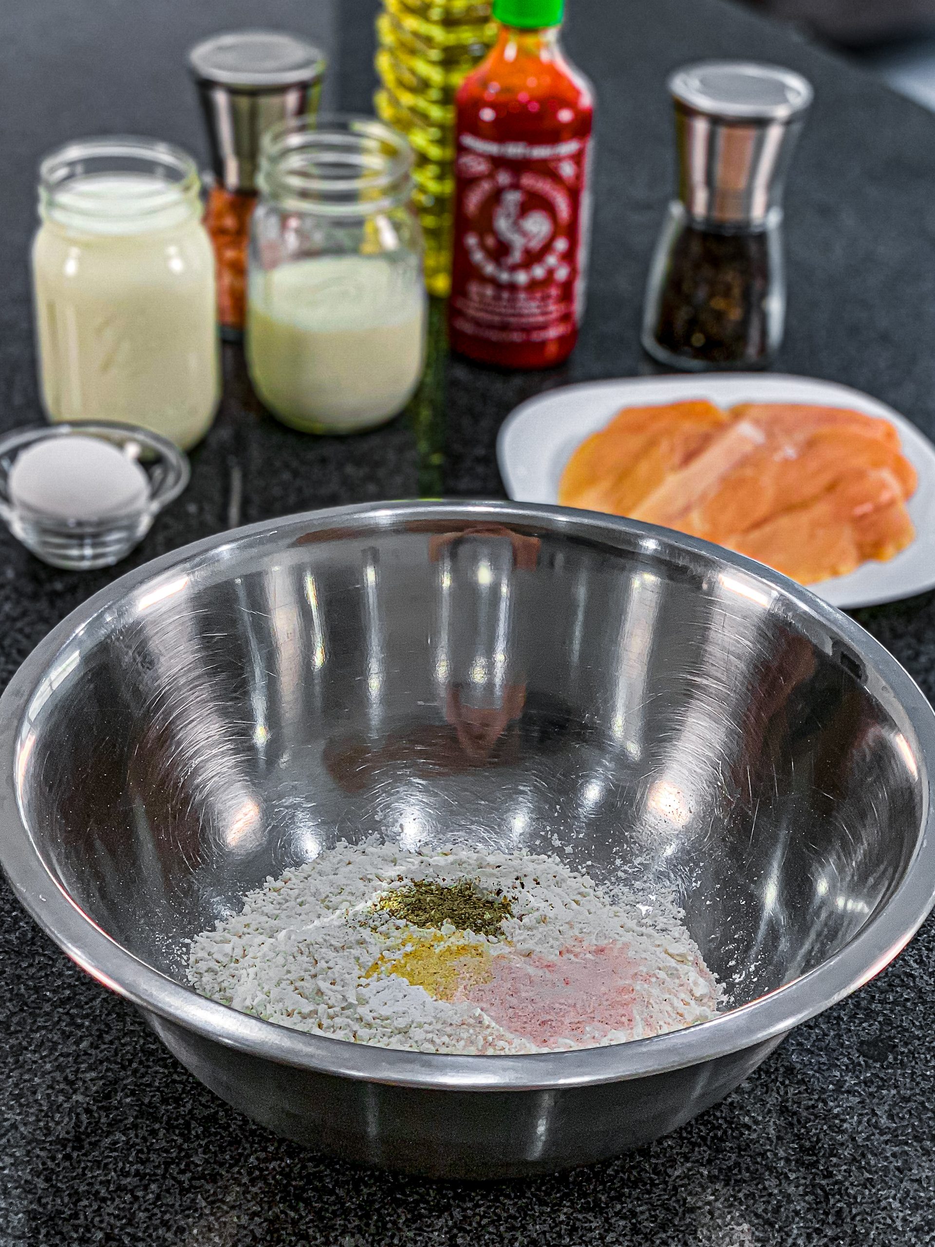  In a large or shallow mixing bowl add the flour, baking powder, baking soda, garlic powder, salt, and pepper. Whisk together until well combined.