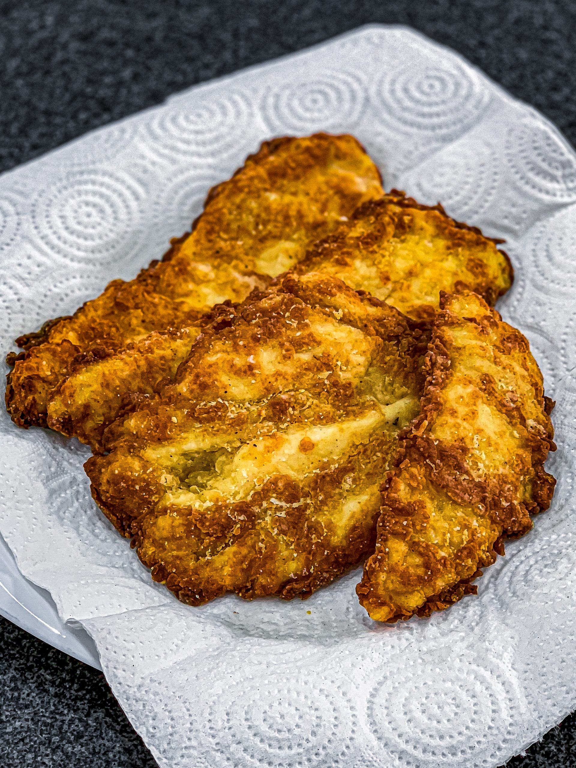 Place the fried chicken on a plate lined with paper towels to drain excess oil.