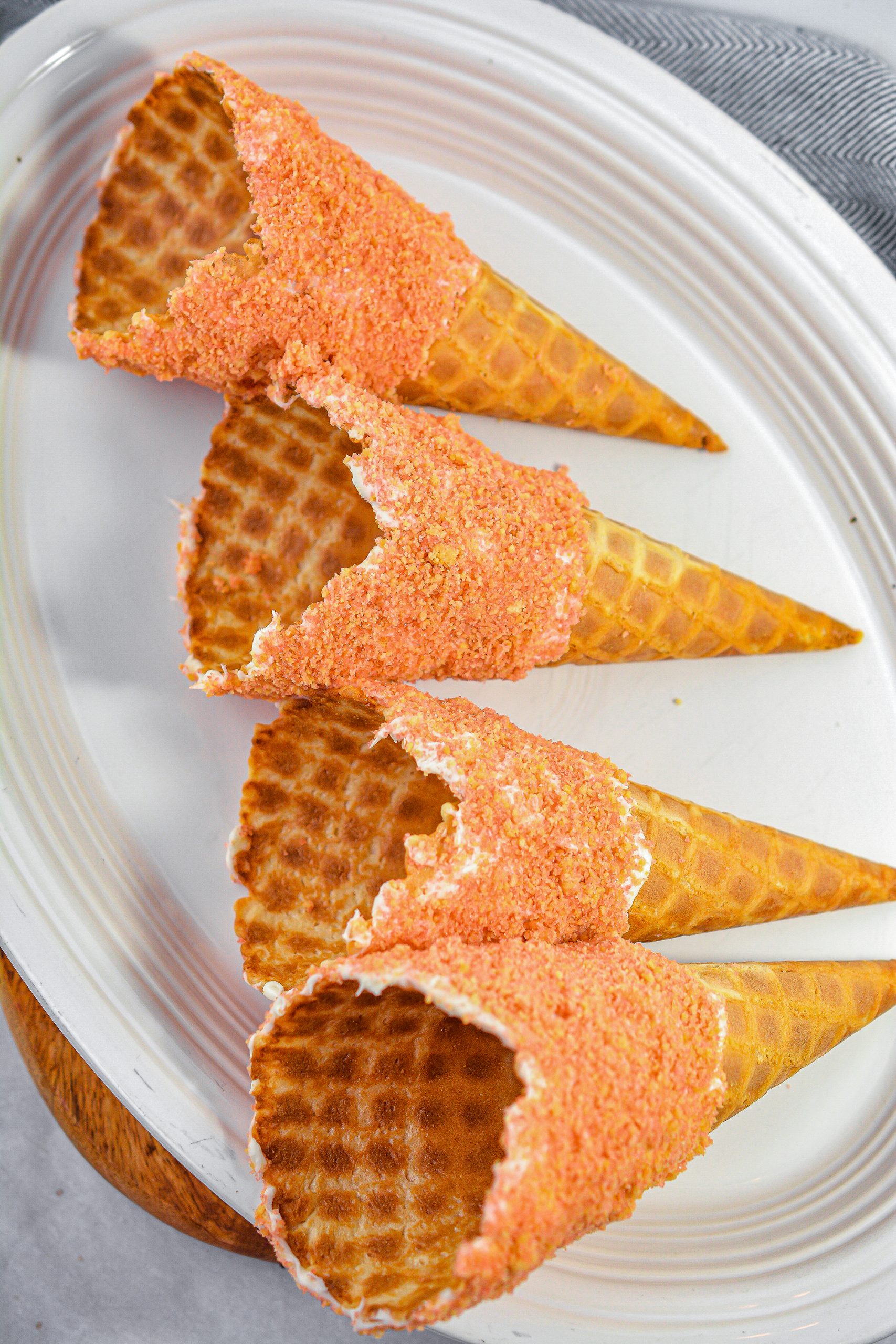 Spread the icing over the top of the outside of the waffle cones, going about halfway down the cone.