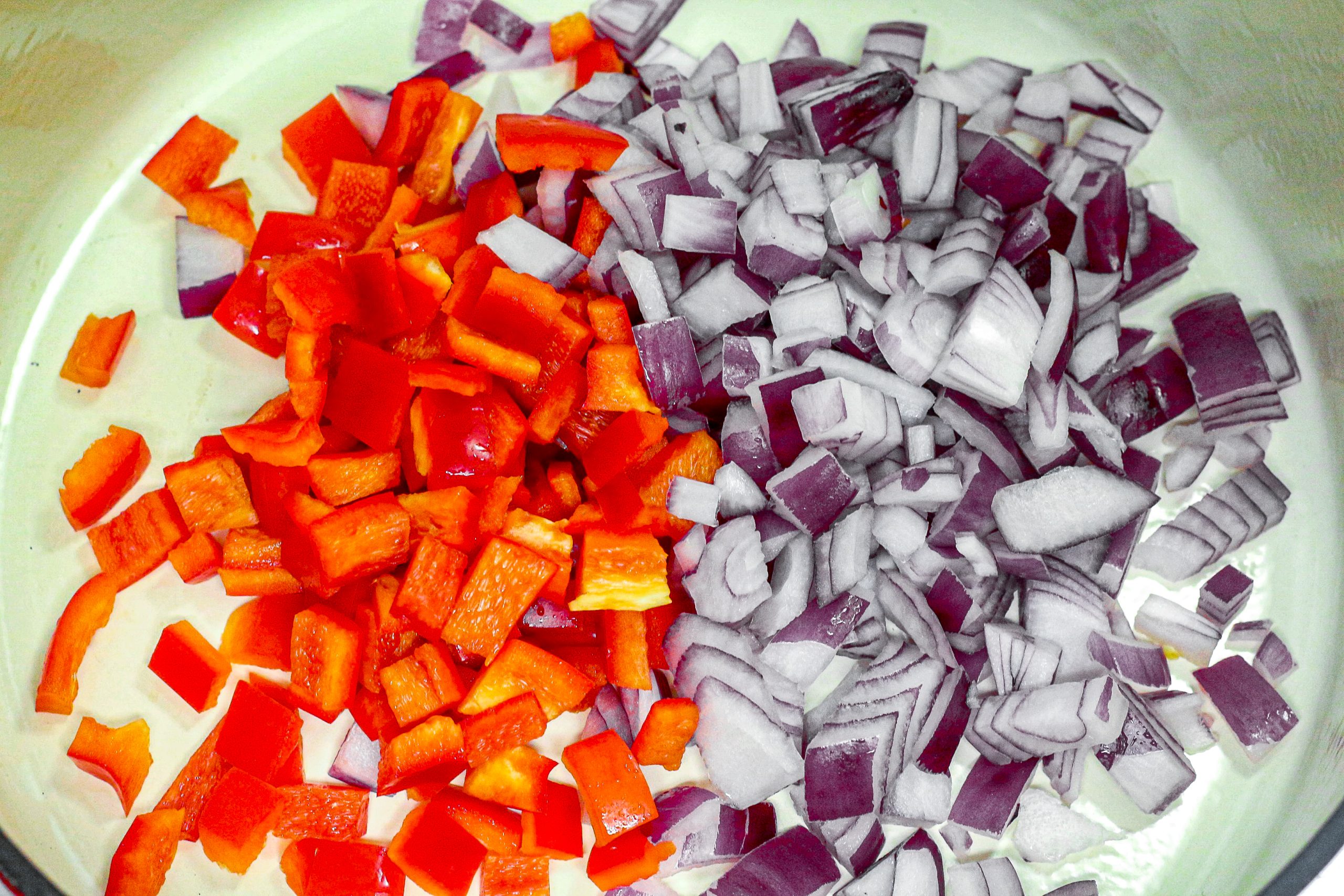 Add the red onion and red bell pepper in a Dutch Oven.