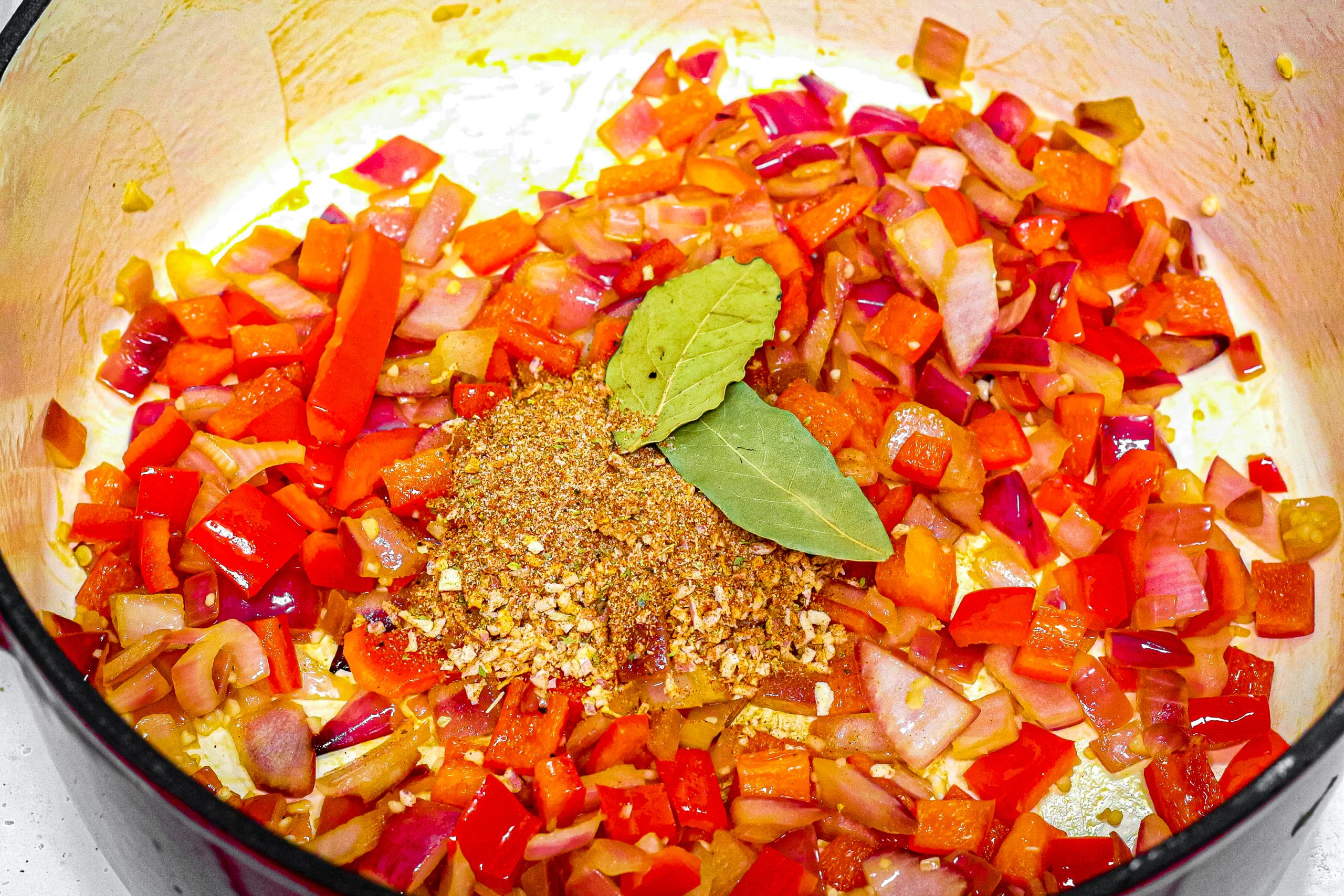 Add the mixed spice ingredients, sauteing for 30 seconds.