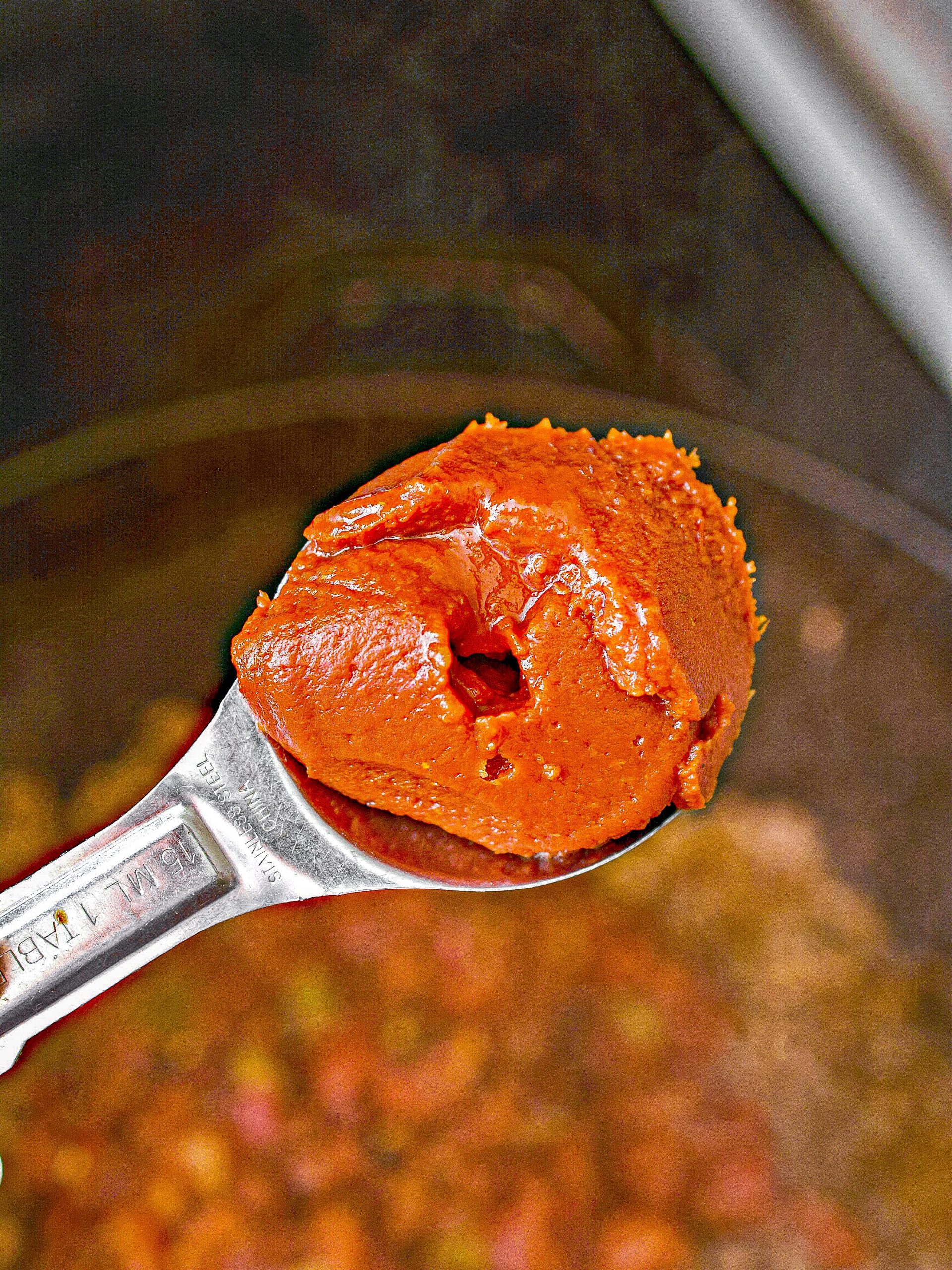 add 2 tbsp tomato paste into the skillet with the meat and stir to combine well.