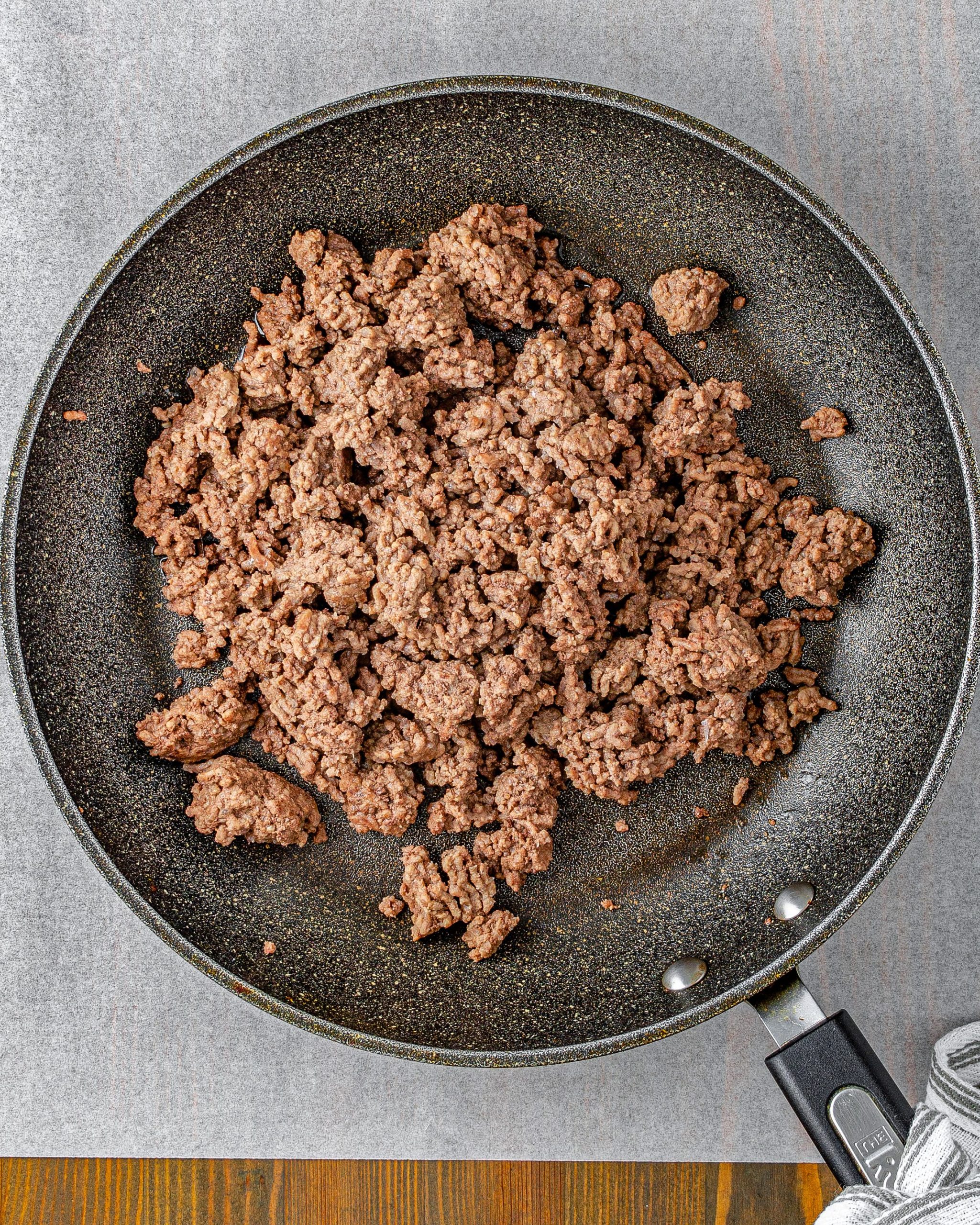Heat the ground beef and onion in a skillet over medium-high heat on the stove. Cook until the meat is completely browned and the onions have softened.