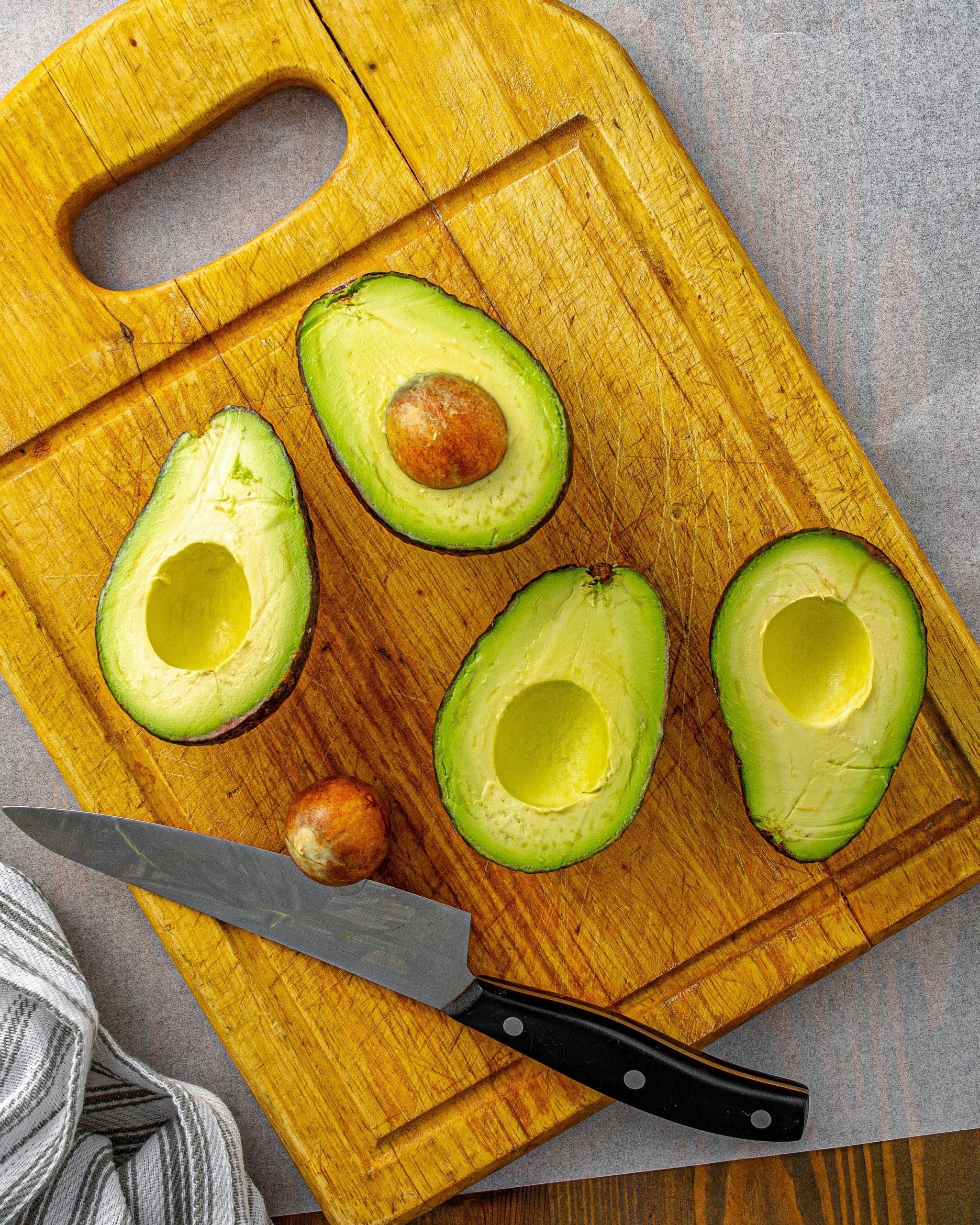 Cut the avocados in half lengthwise and remove the pit.