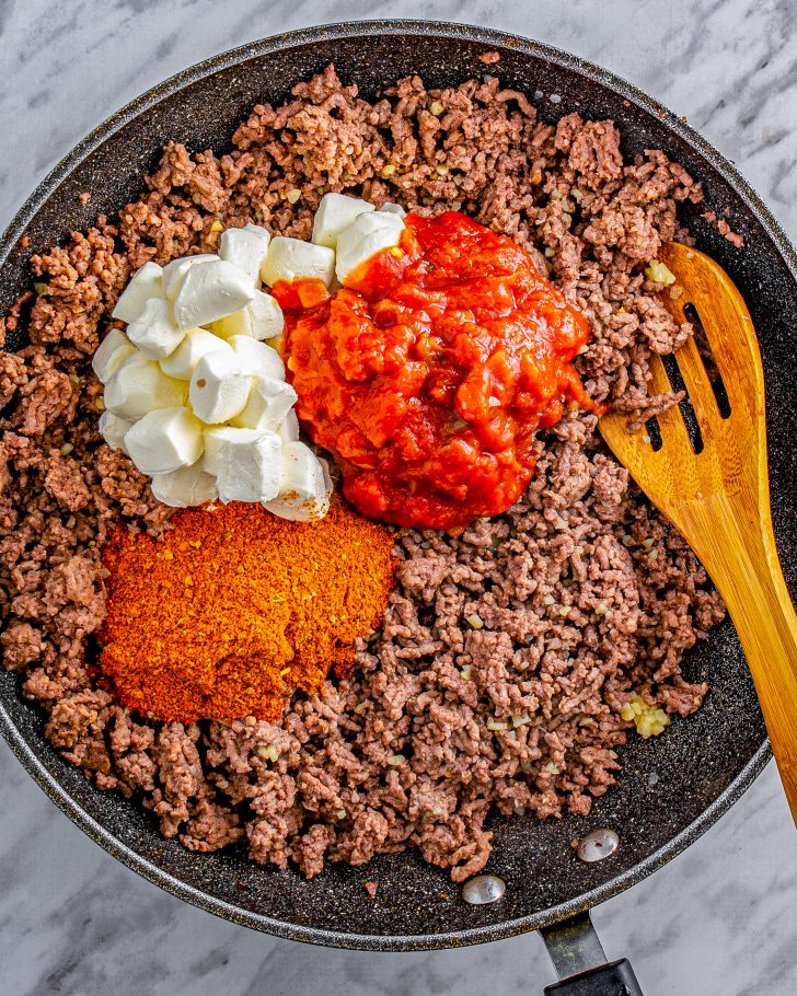 Add the taco seasoning packet, cream cheese, and salsa to the skillet with the beef.