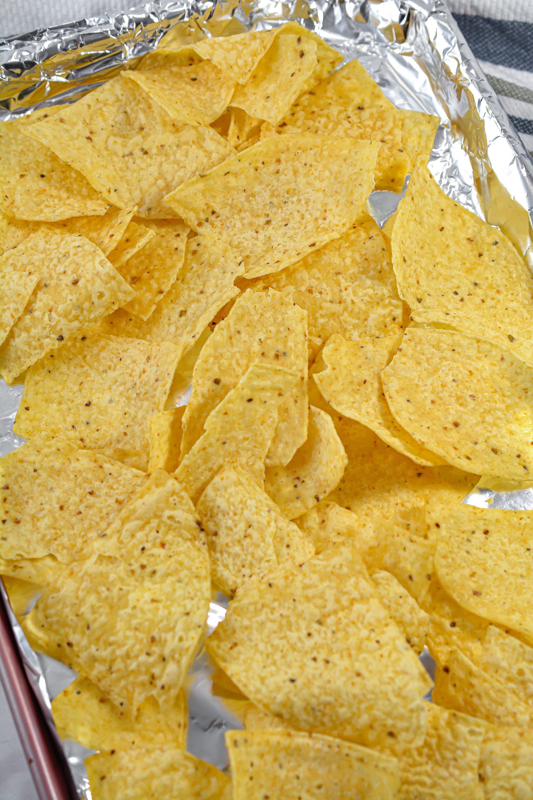 Spread a layer of chips on the baking sheet.