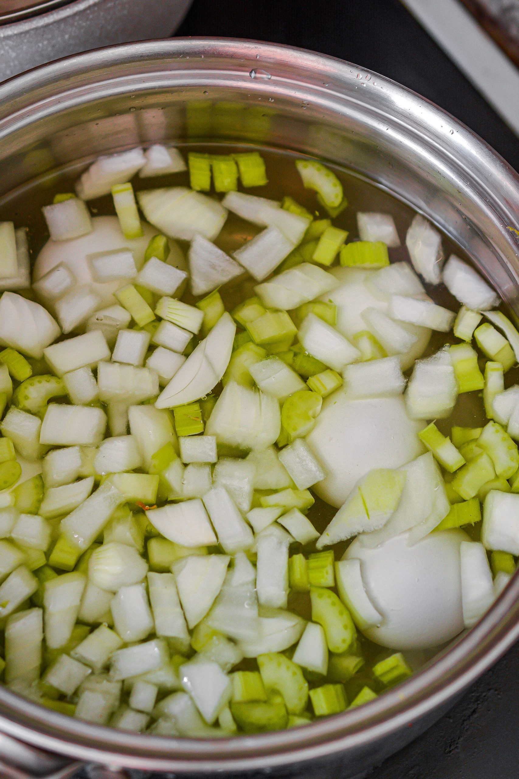 Add the onion and celery to a pot with the eggs and cover with water. Bring to a boil and cook for 15 minutes. Drain, rinse the eggs in cold water, peel the eggs and chop them well.