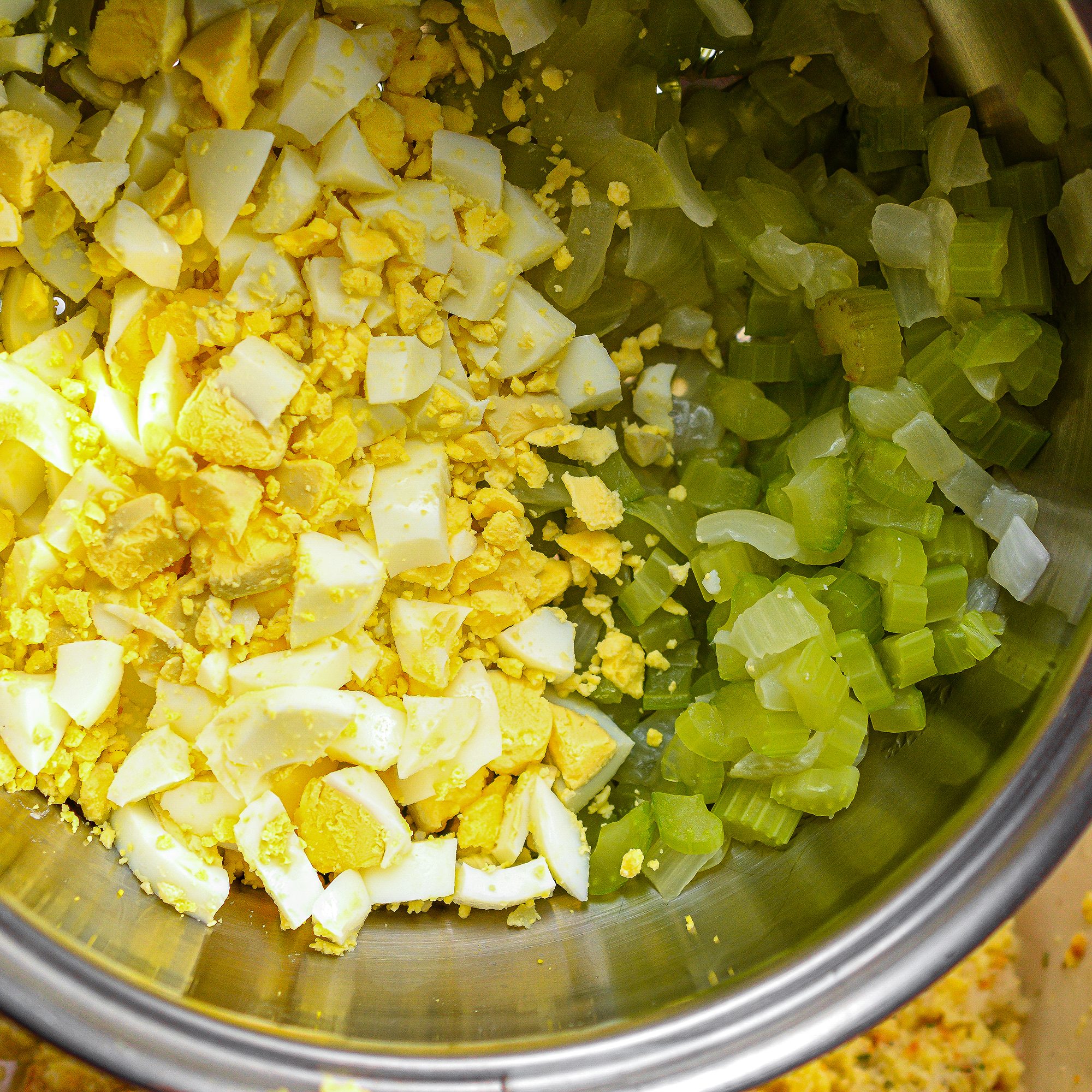 Adding onion, celery, chopped eggs