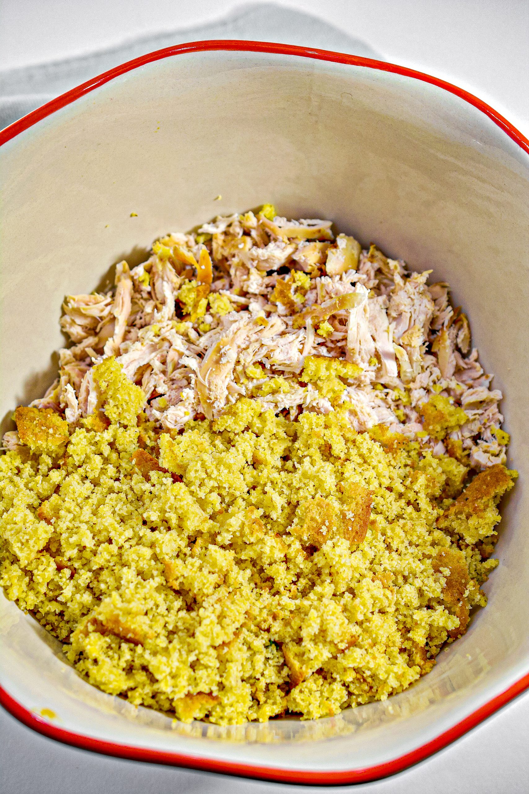 Mix together the crumbled cornbread, chicken, and cooked vegetables in a large mixing bowl.