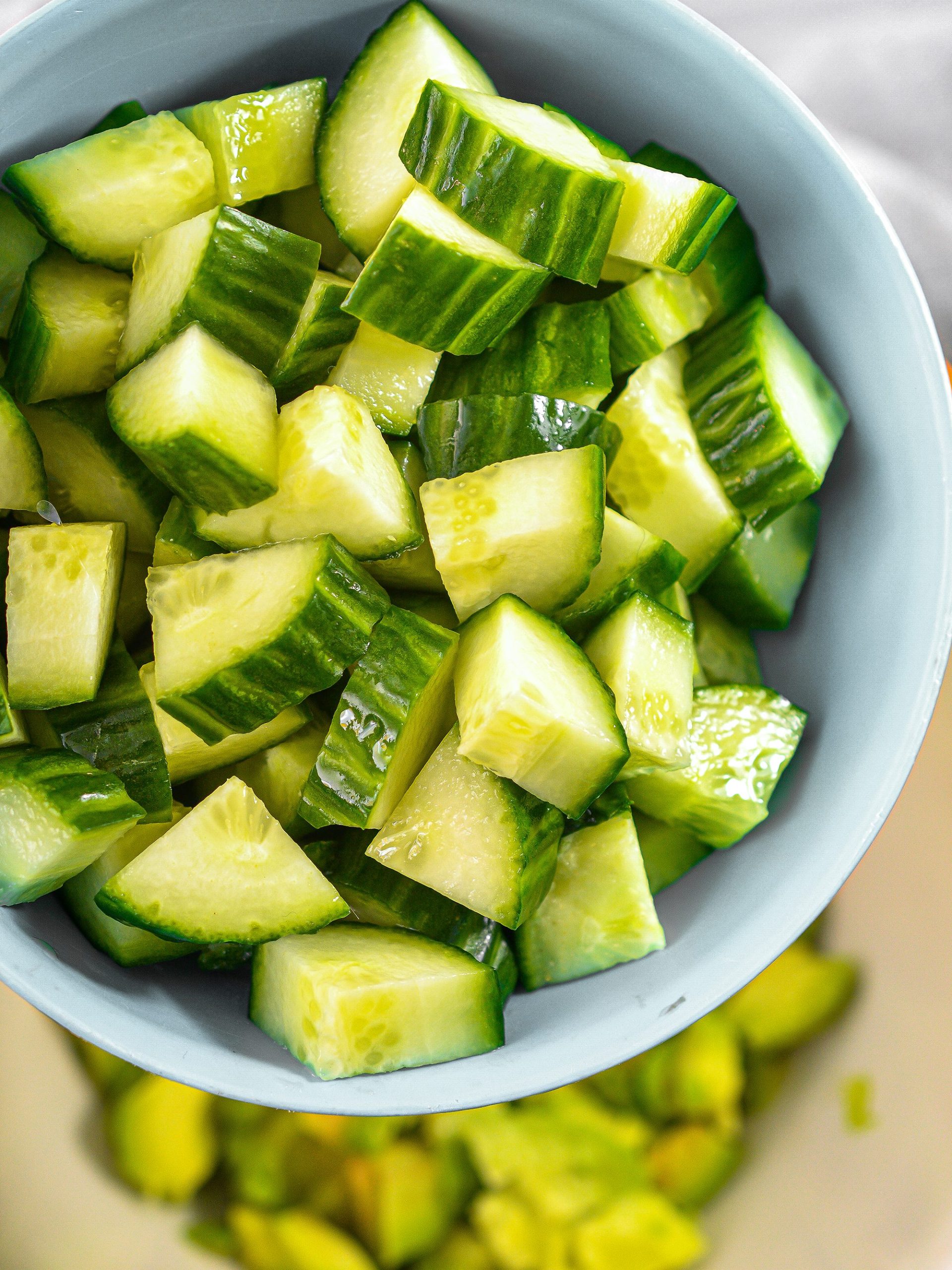 In a mixing bowl, stir together the cucumber, avocado and tomato.