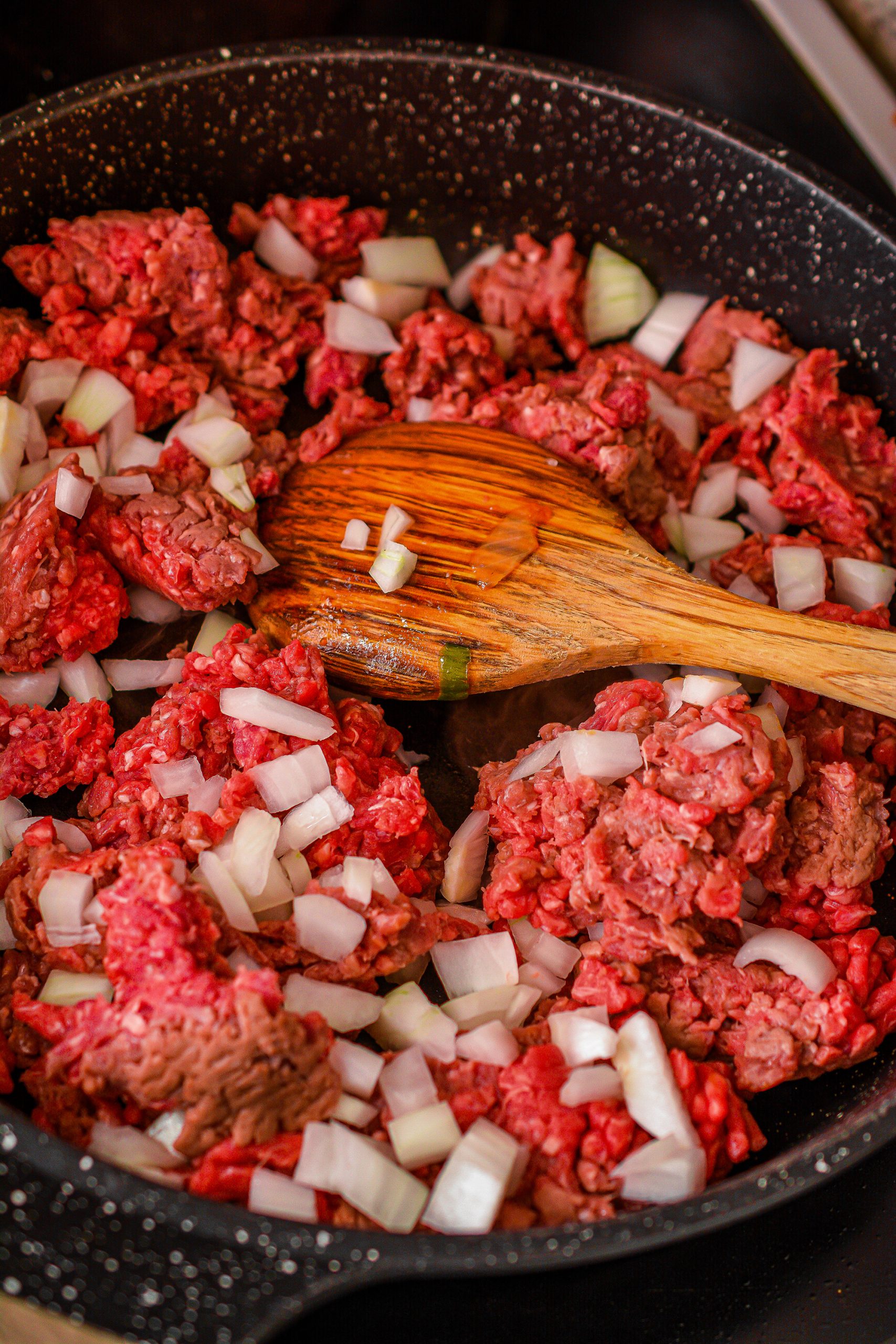Add the ground beef and onion to a skillet over medium high heat.