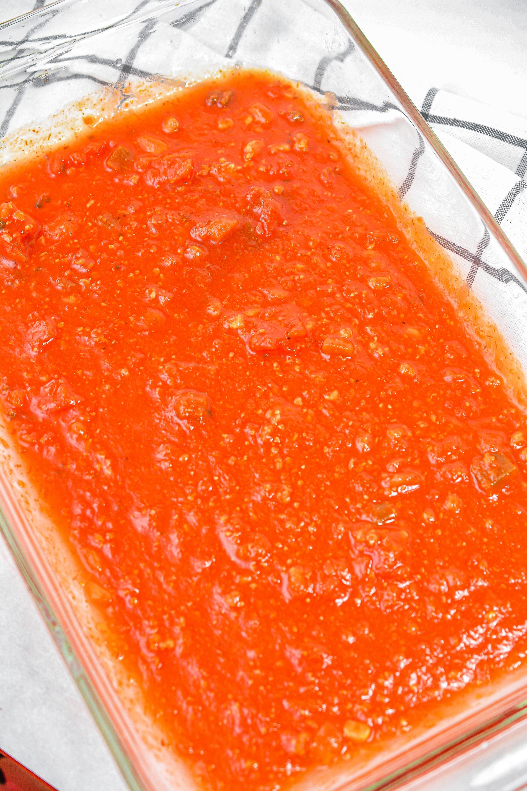 Layer 1 cup of spaghetti sauce in the bottom of a 9x13 baking dish.