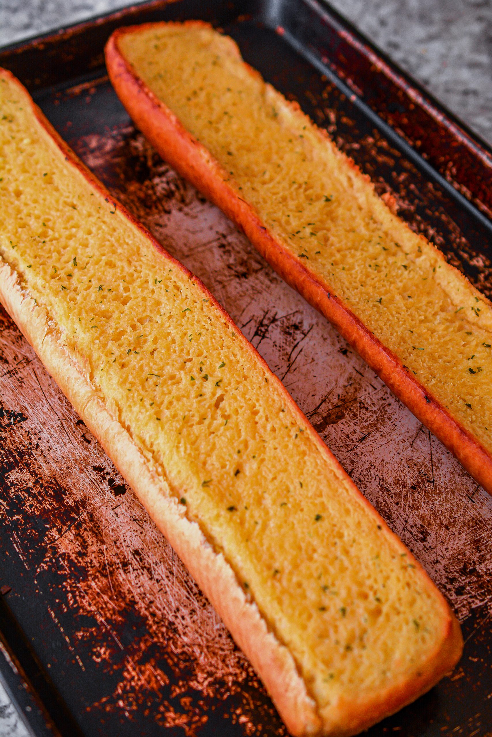 Bake the garlic bread to package instructions and leave the oven on when done.