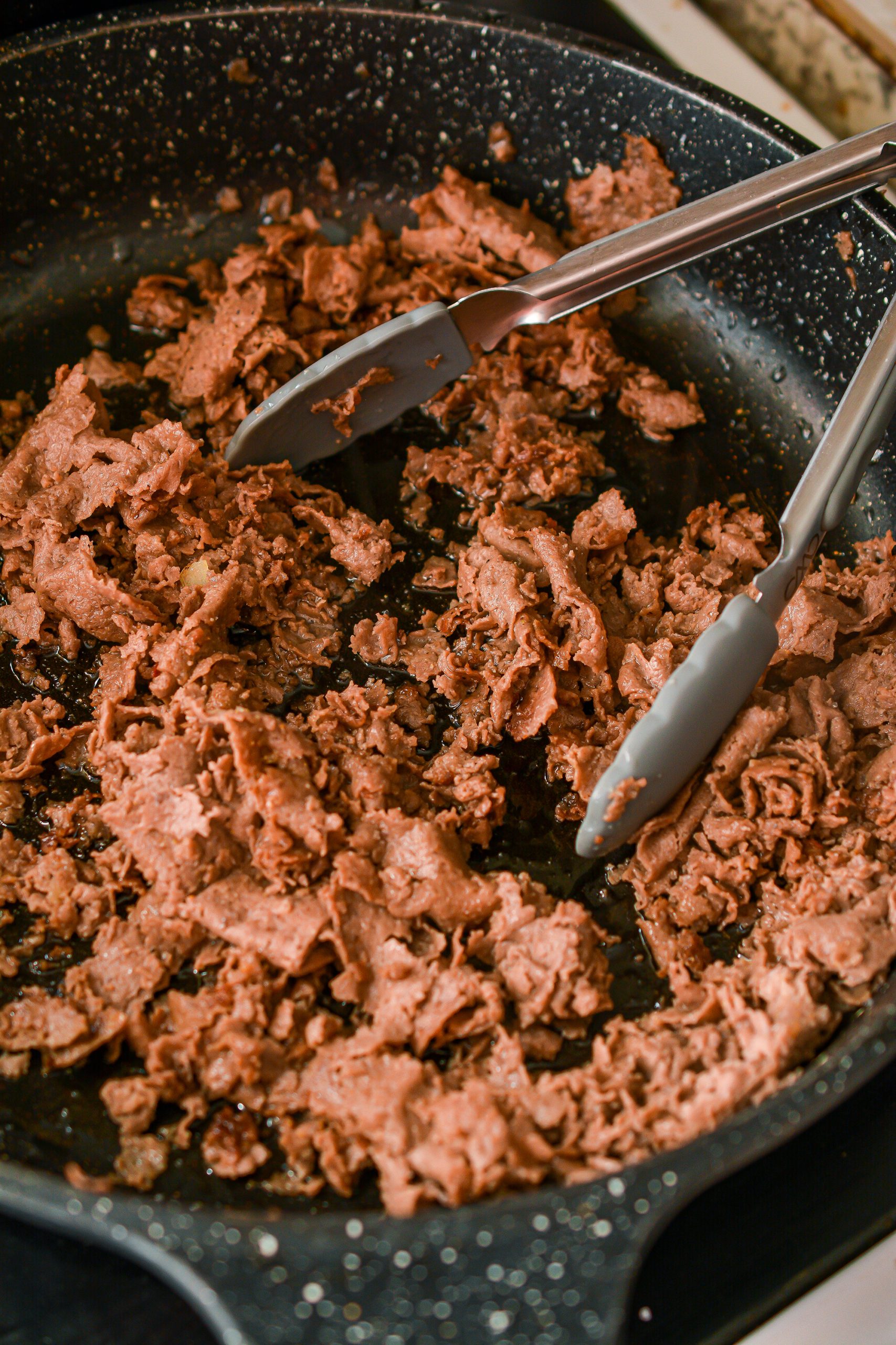 Cook the meat over medium high heat until browned completely, and drain any excess fat.