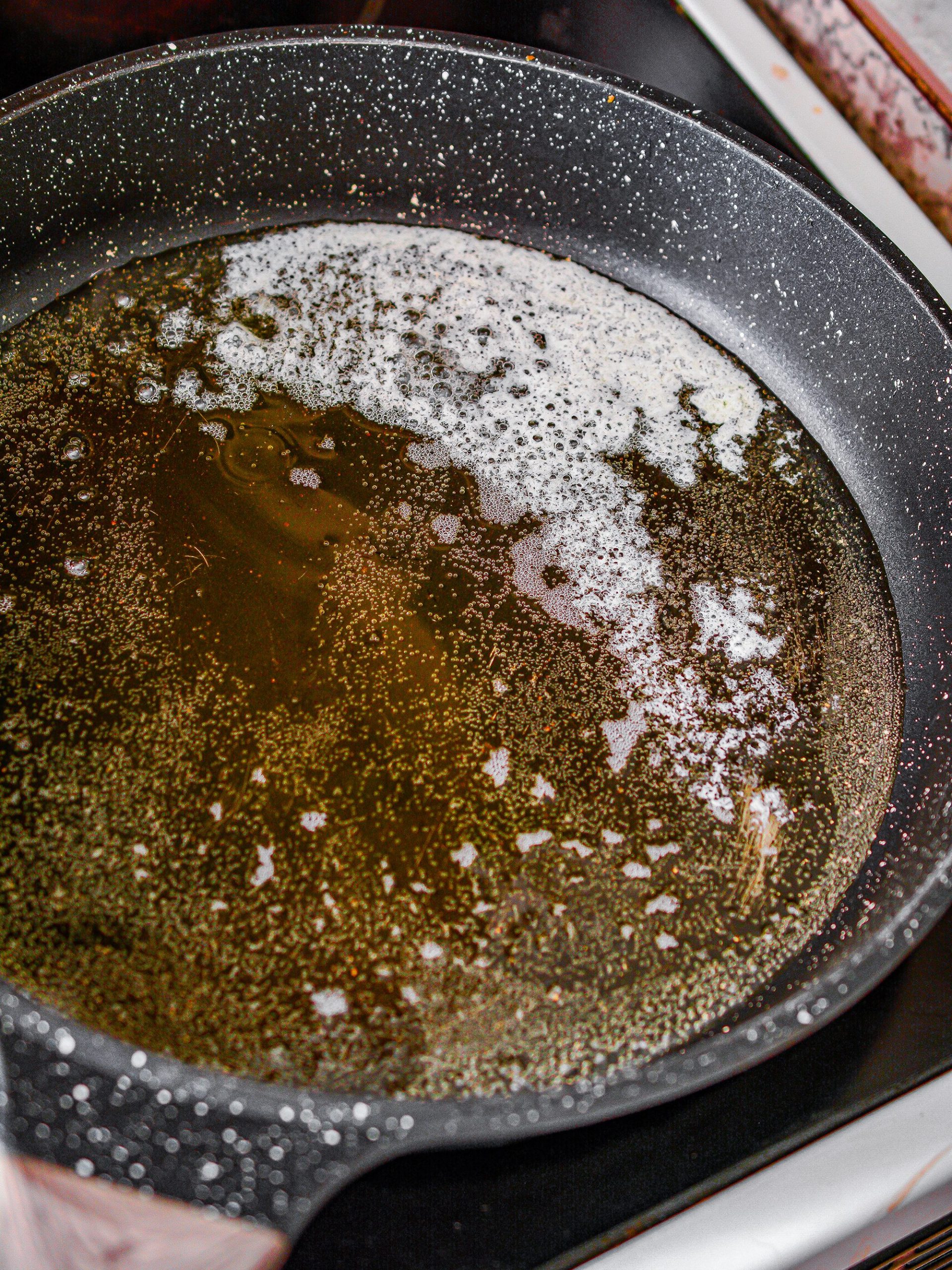 Heat a layer of peanut oil and the butter in a skillet over medium-high heat.
