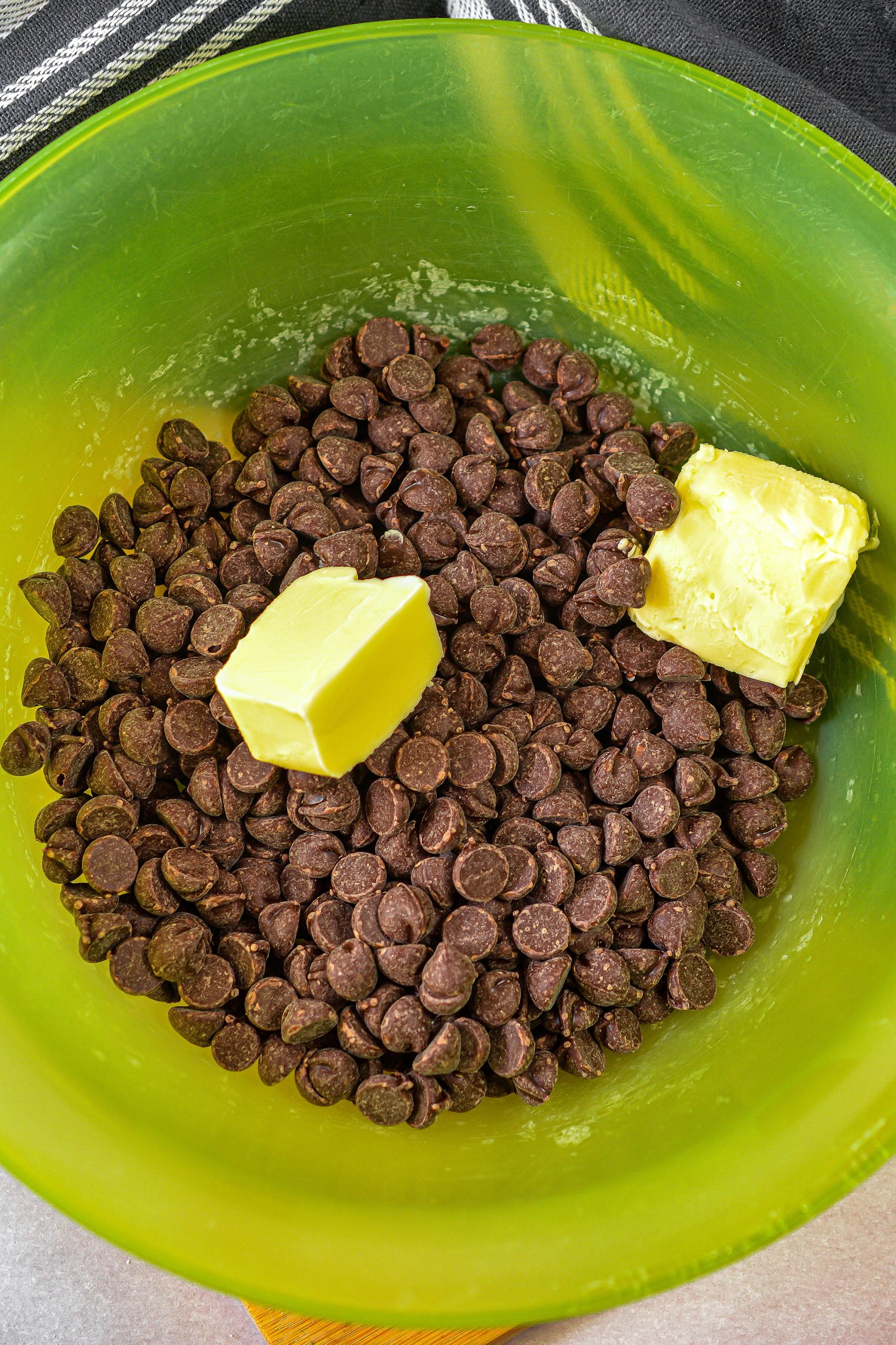 In a microwave safe bowl, combine the 2 tbsp butter and the 8 oz chocolate chips. 