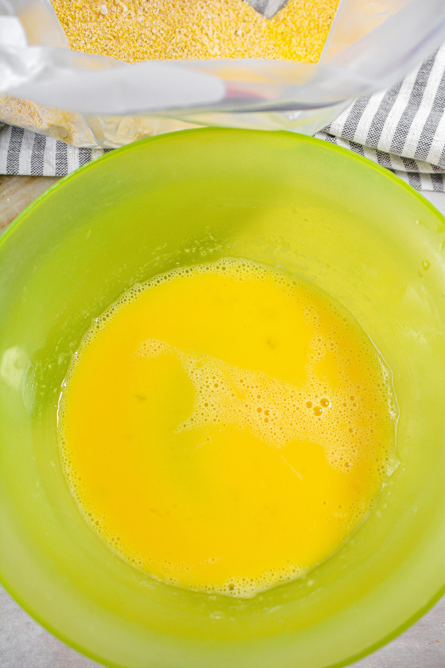 Whisk together the eggs in a large bowl.
