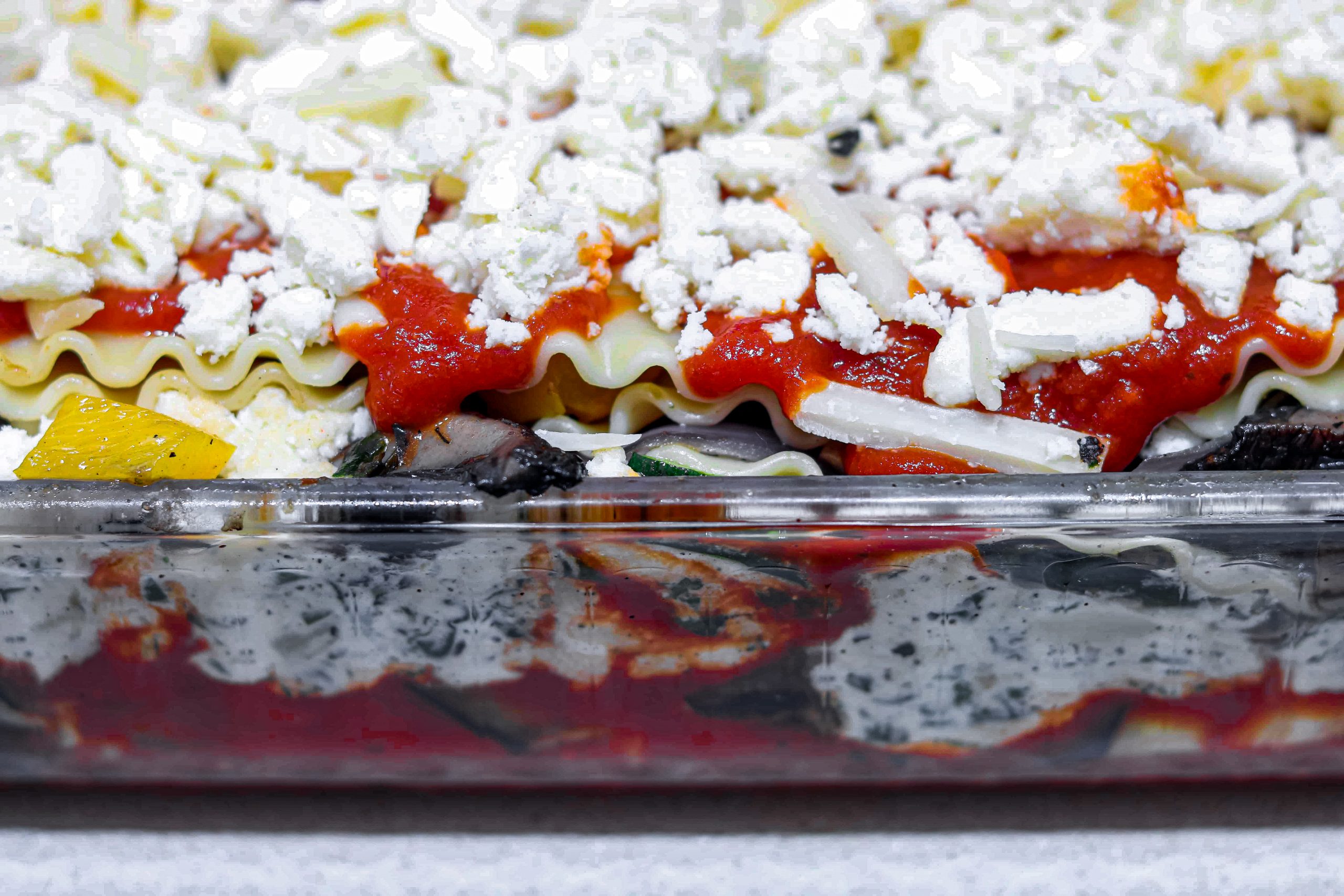 Layer all grilled veggies in a pan with cooked lasagna noodles, sauce, ricotta, and cheese. Bake. Serve hot.