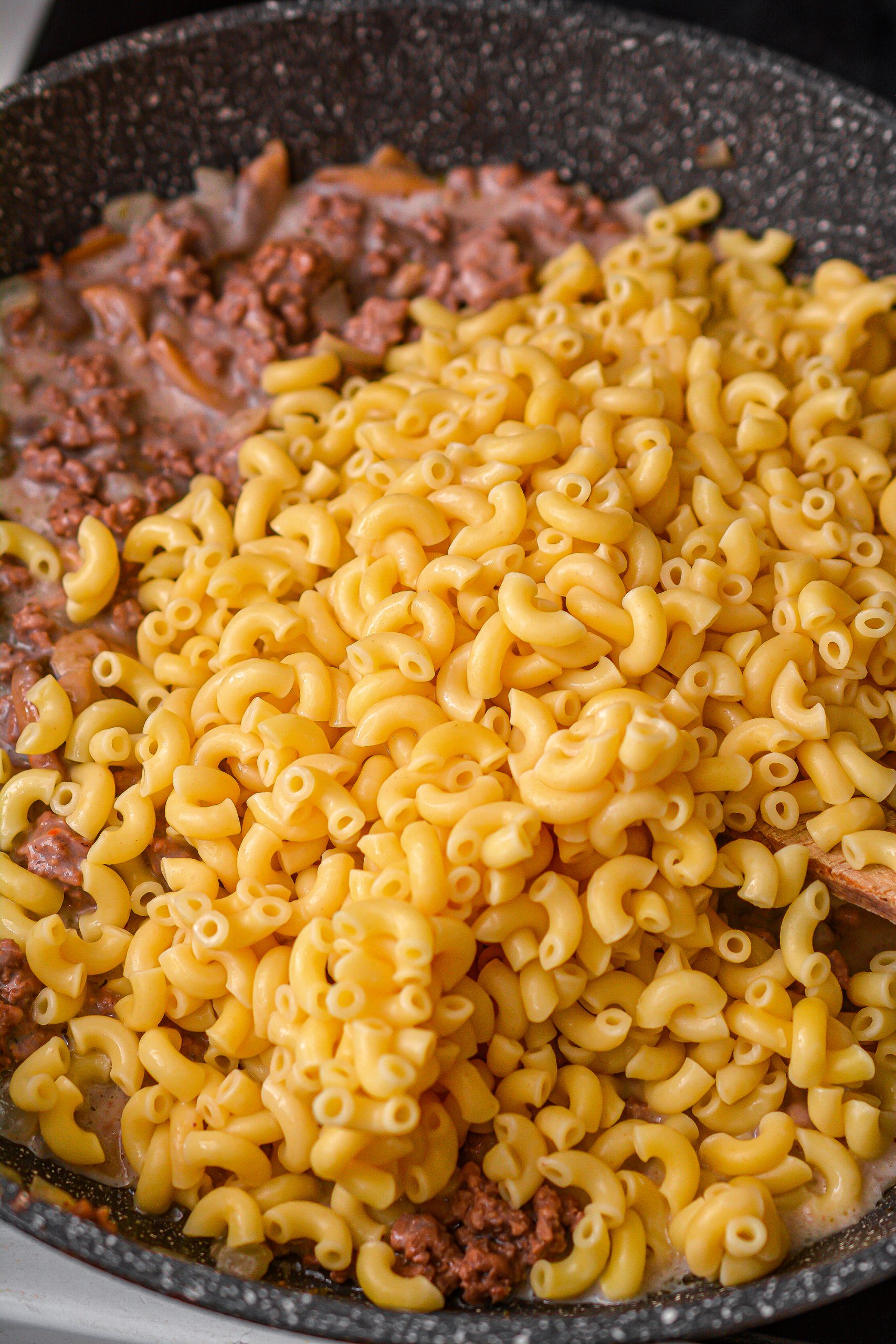 Add the macaroni to the skillet and stir to combine. 