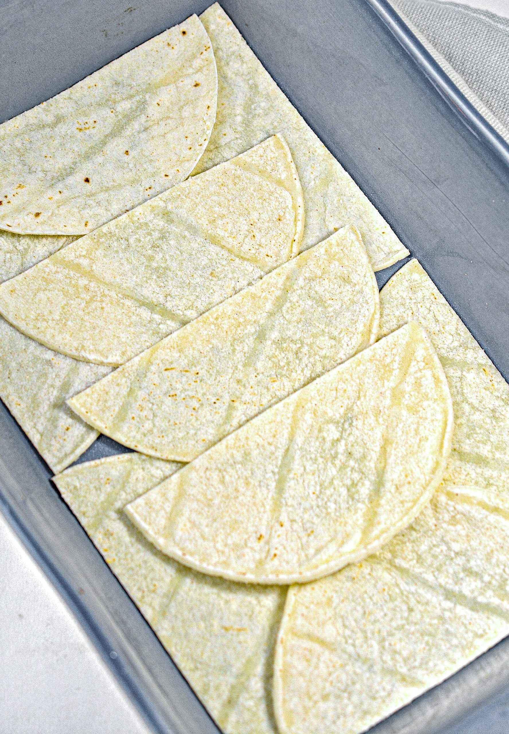 Place a layer of corn tortilla in the bottom of a well-greased 9x13 baking dish.