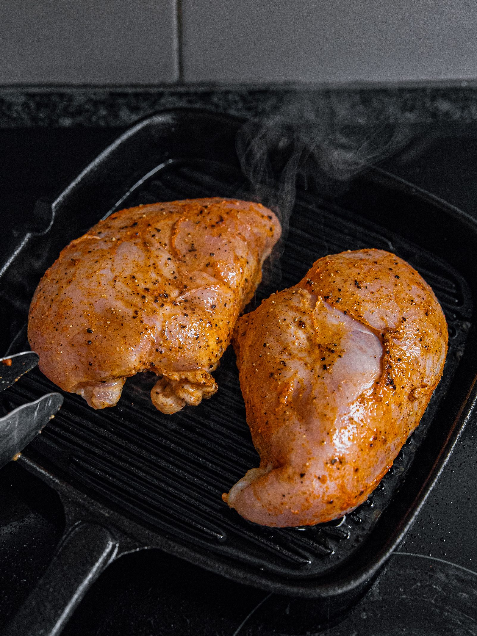 Preheat grill to medium heat. Place chicken on the grill and cook for around 5 - 6 minutes on each side, ensuring the internal temperature of the chicken reaches 165˚F. Cut into small pieces and set aside.