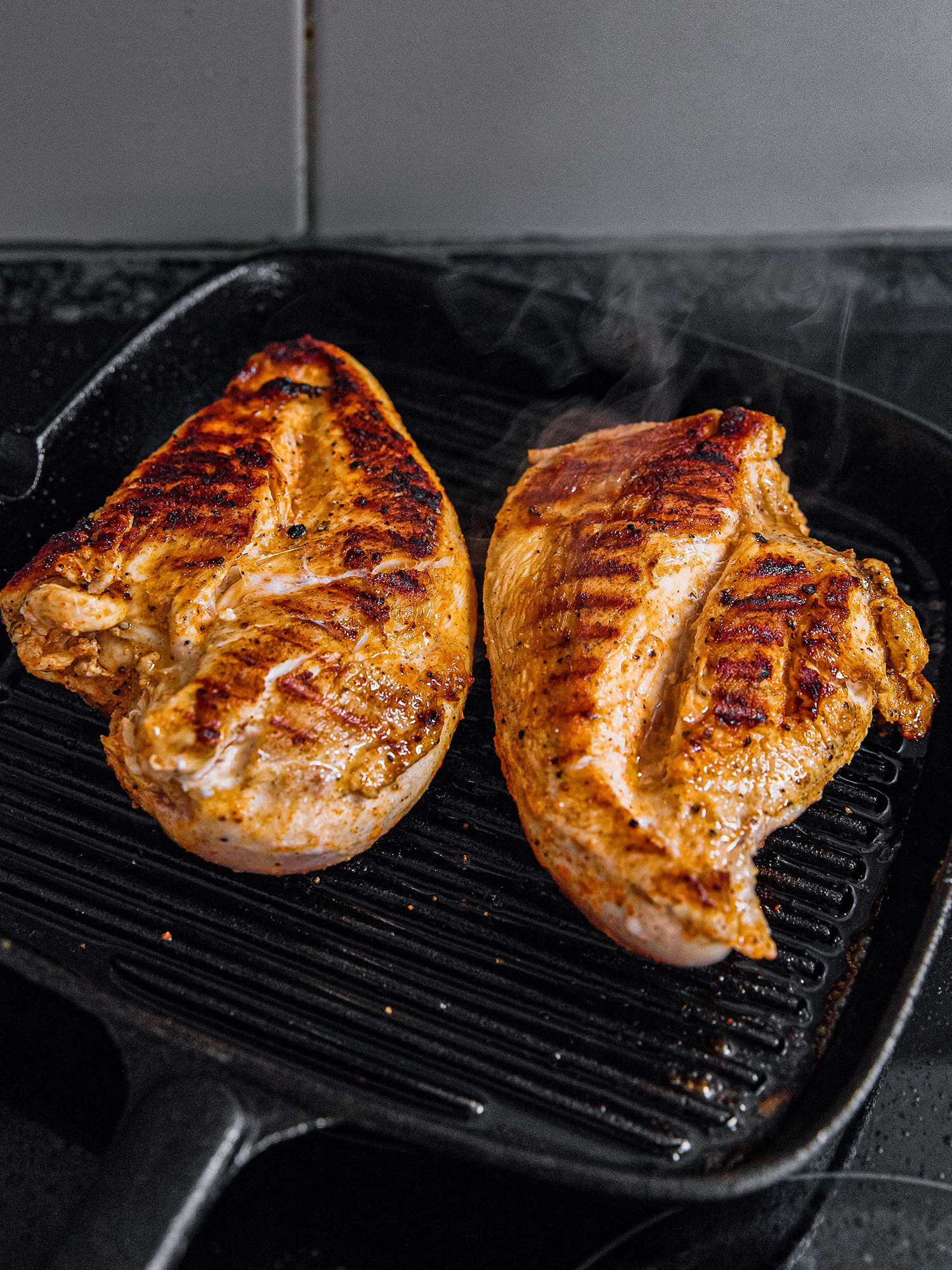 Preheat grill to medium heat. Place chicken on the grill and cook for around 5 - 6 minutes on each side, ensuring the internal temperature of the chicken reaches 165˚F. Cut into small pieces and set aside.