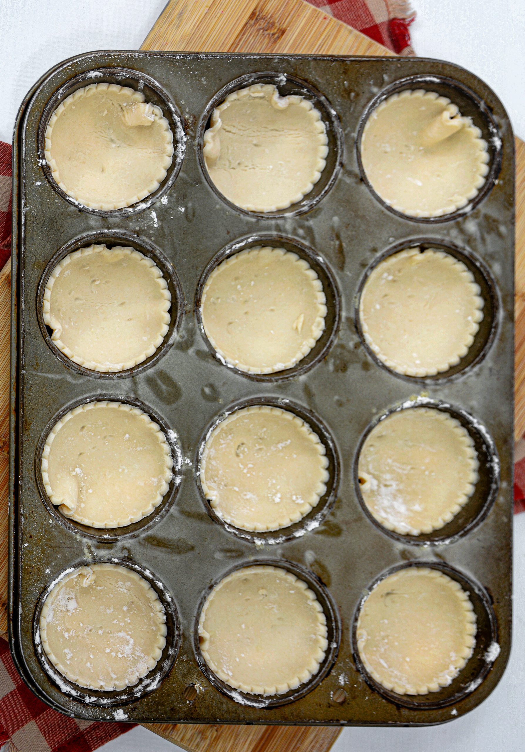 Second, use a straw to make six small holes in the top crust of each pot pie.