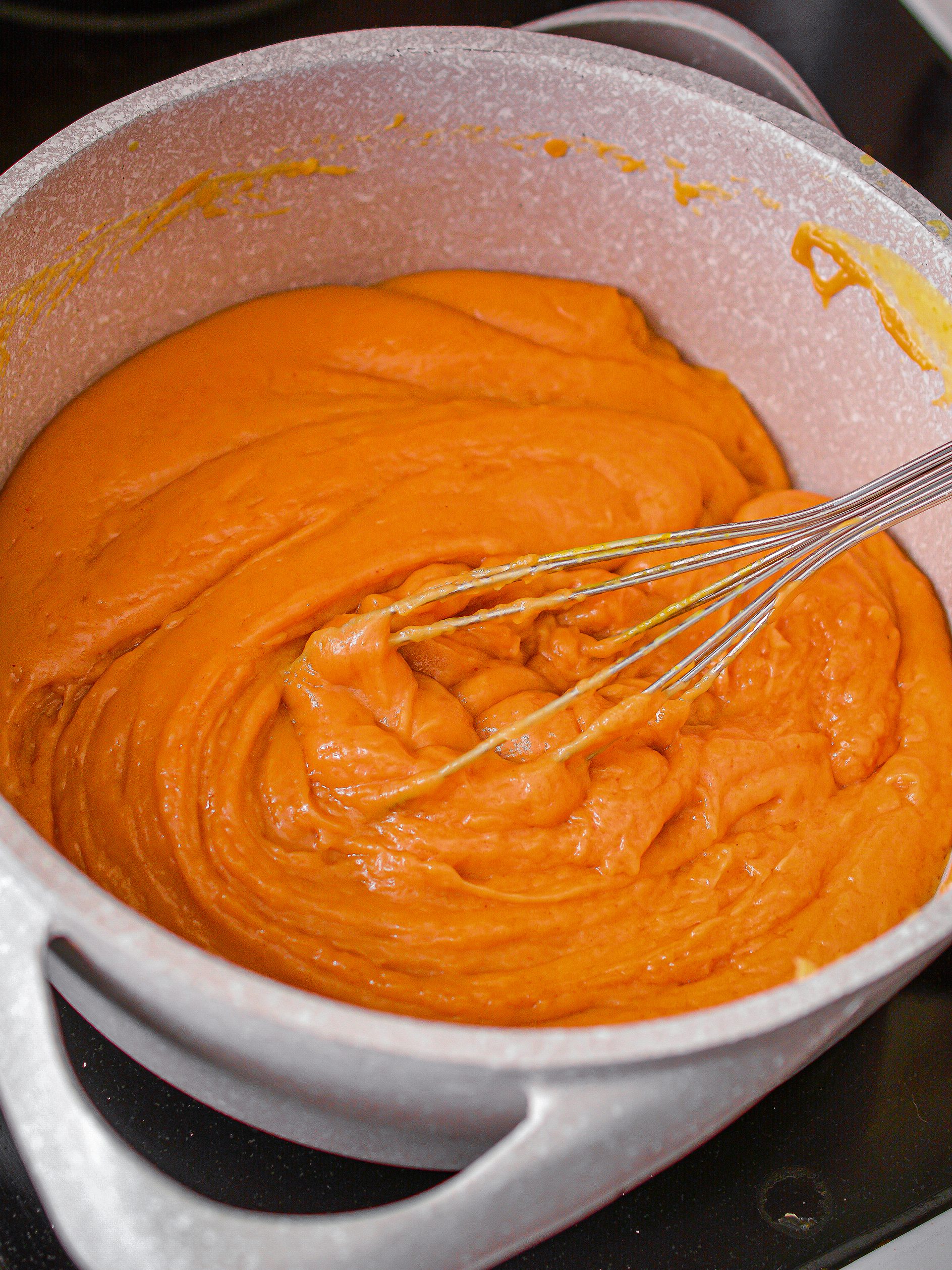 Reduce the heat to a simmer and add in the peanut butter until the mixture has thickened and is smooth.
