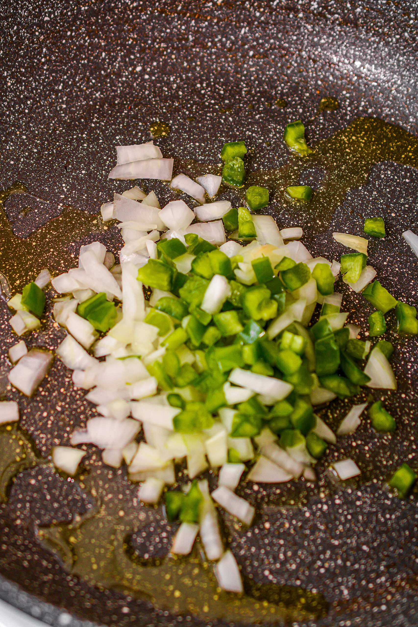 In a skillet, heat olive oil and cook the onions and pepper until tender. 