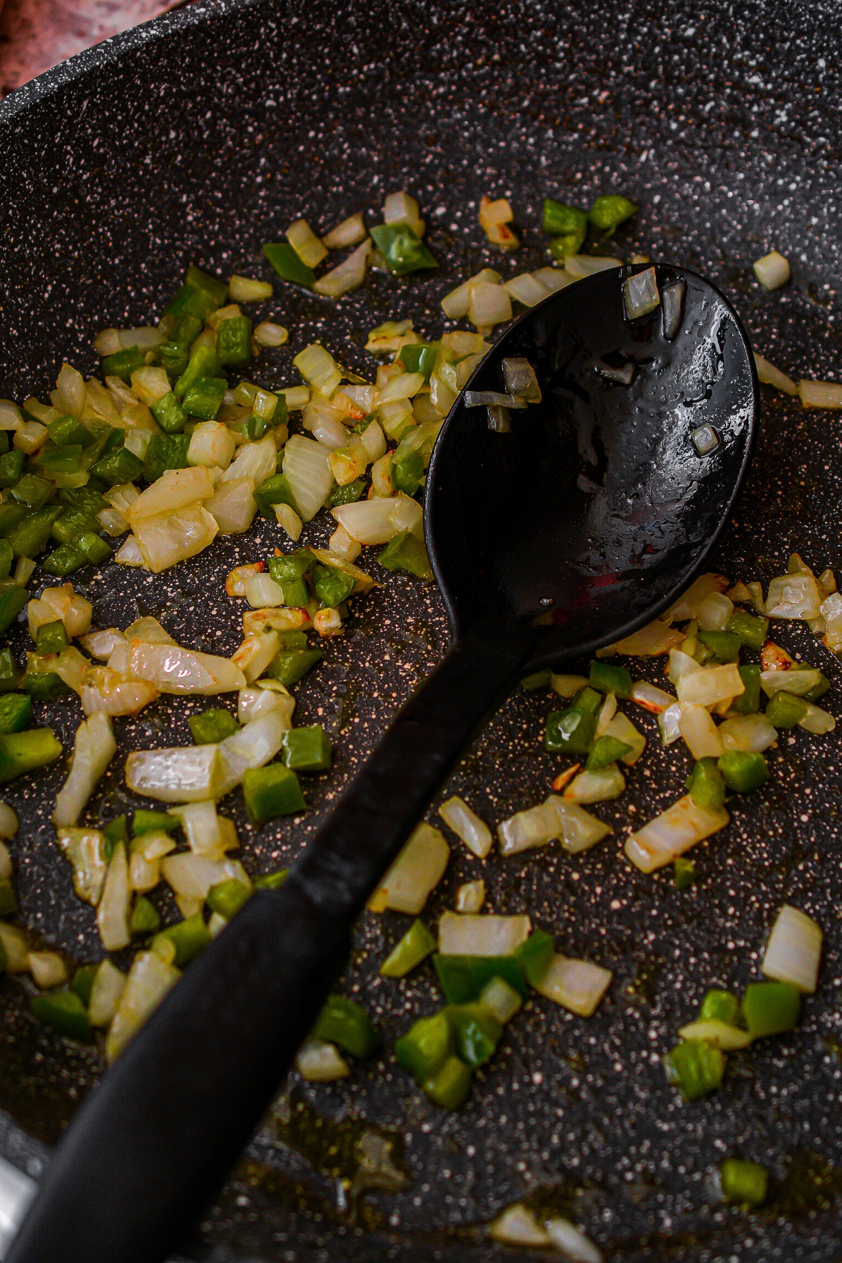 In a skillet, heat olive oil and cook the onions and pepper until tender. 