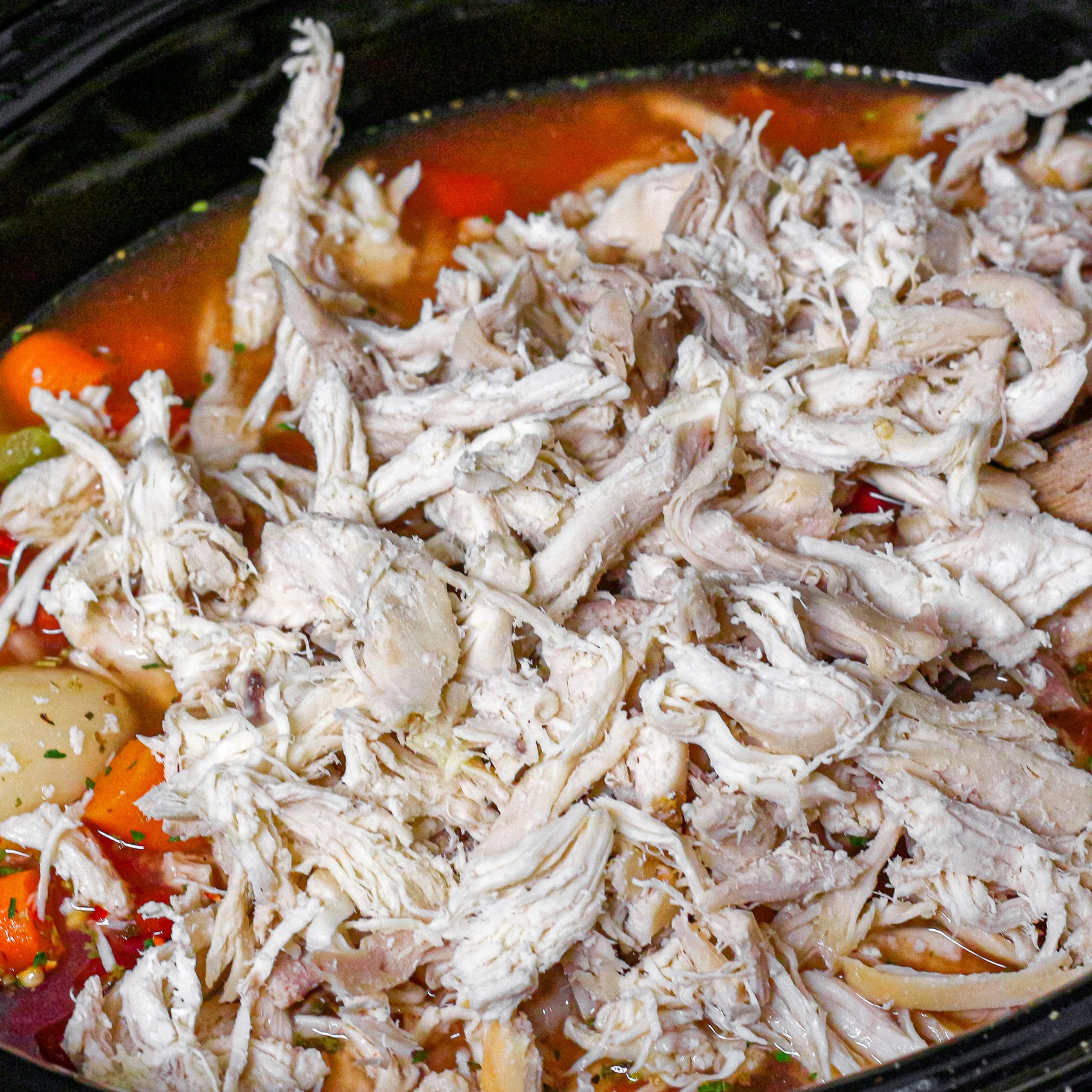 Add the chicken, vegetables, tomatoes, about 8 cups of water, parsley, minced garlic, salt, and pepper in a crockpot.