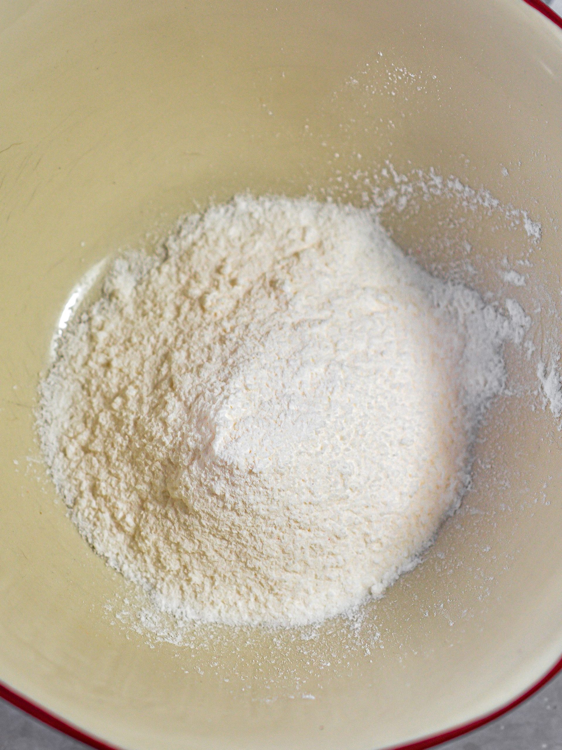 In a mixing bowl, blend together the cream cheese and sour cream until smooth.