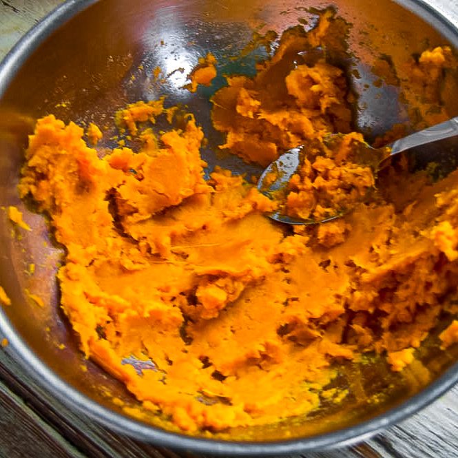 Once cool, break open skin and scoop out the insides of sweet potatoes into a bowl.