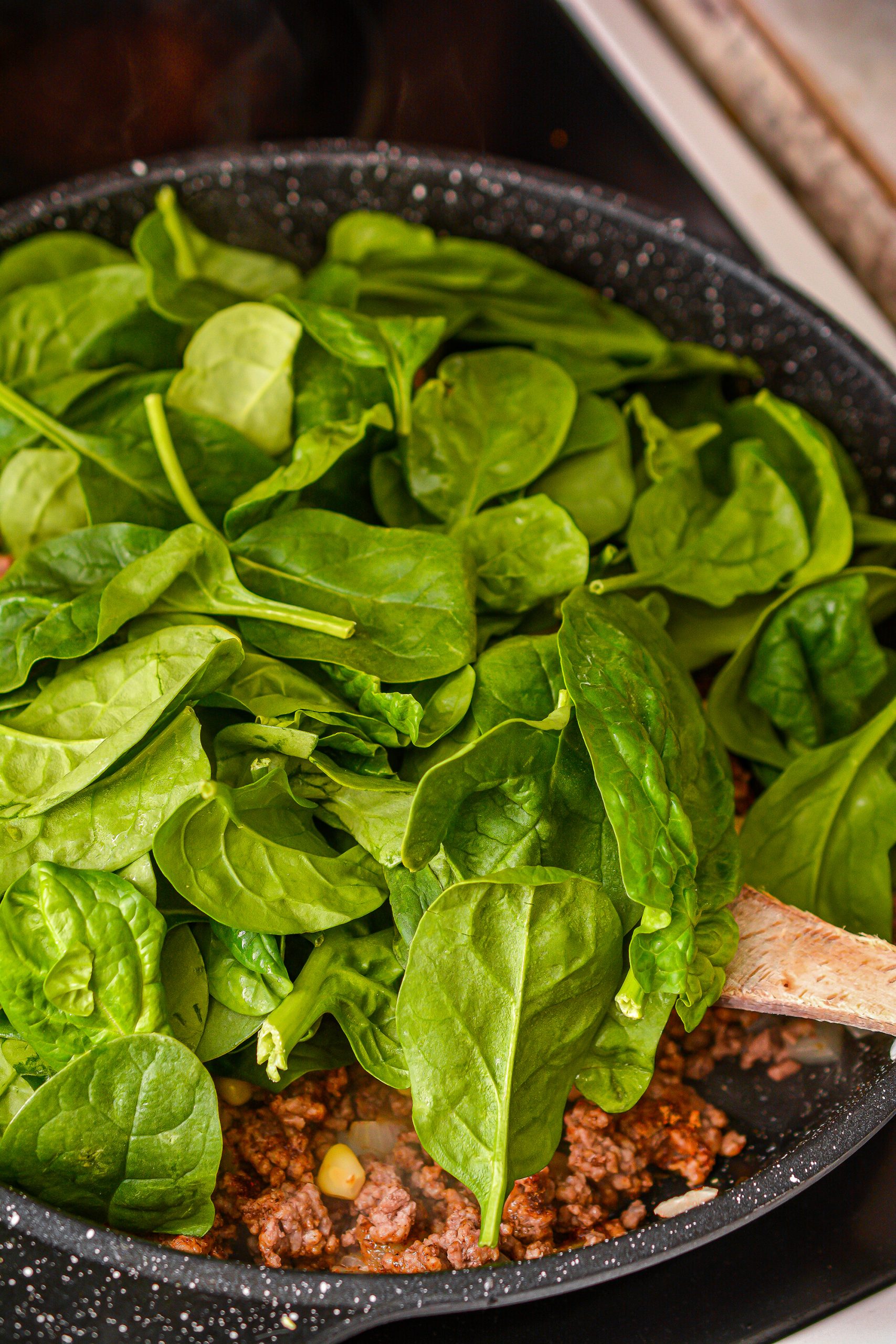 Mix in the taco seasoning, corn, and spinach until the spinach has completely melted.