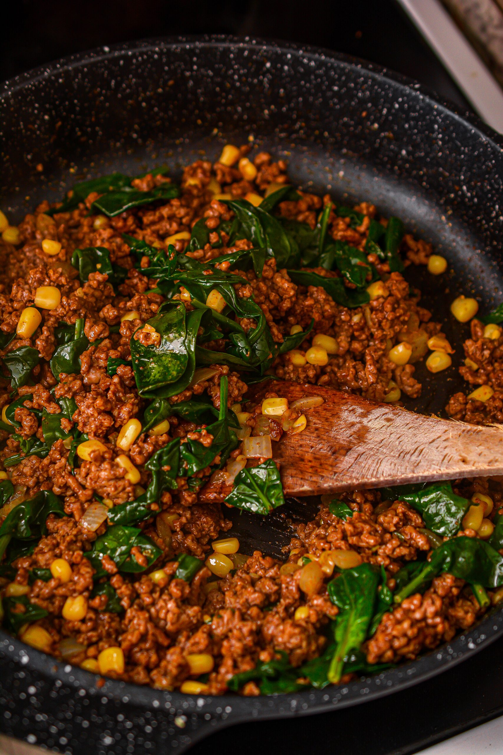Mix in the taco seasoning, corn, and spinach until the spinach has completely melted.