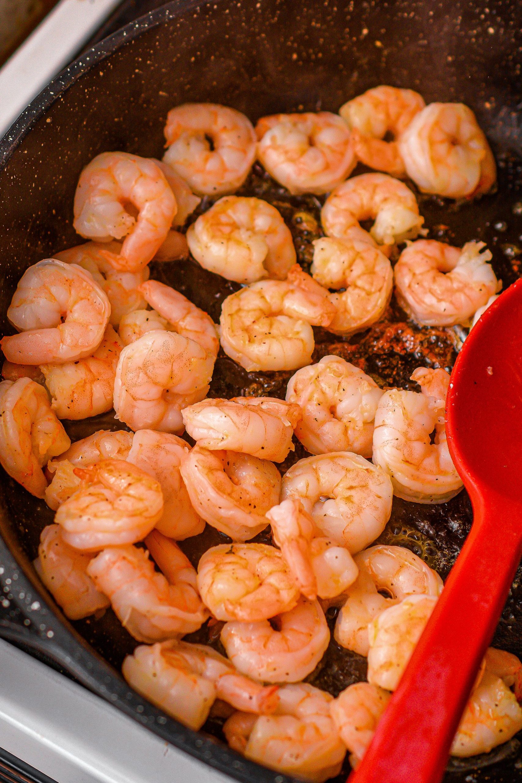 Add the shrimp to the skillet and season with salt and pepper. Saute until cooked through, then remove and set aside.