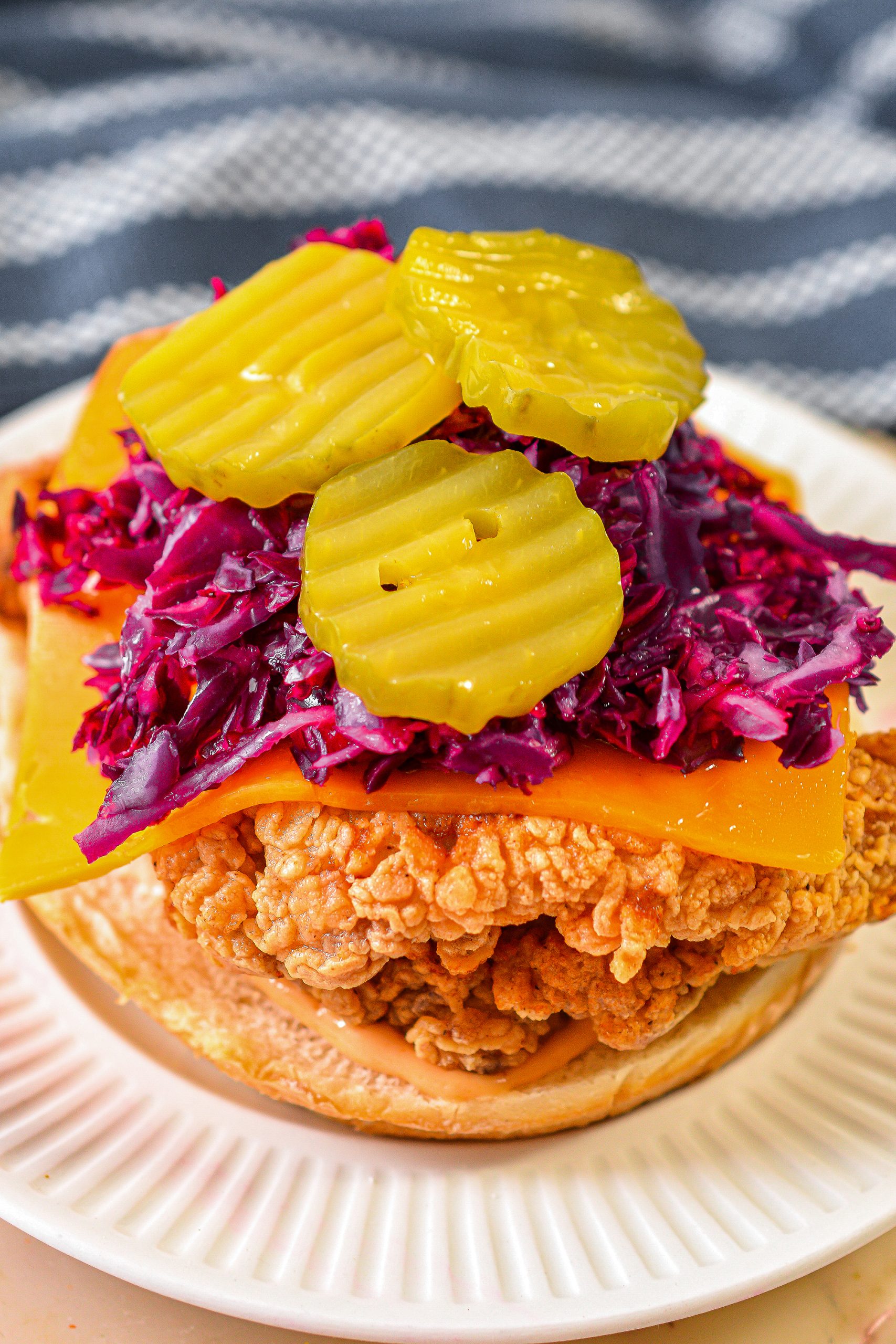  Add some slaw and sliced pickles to the top of each sandwich.