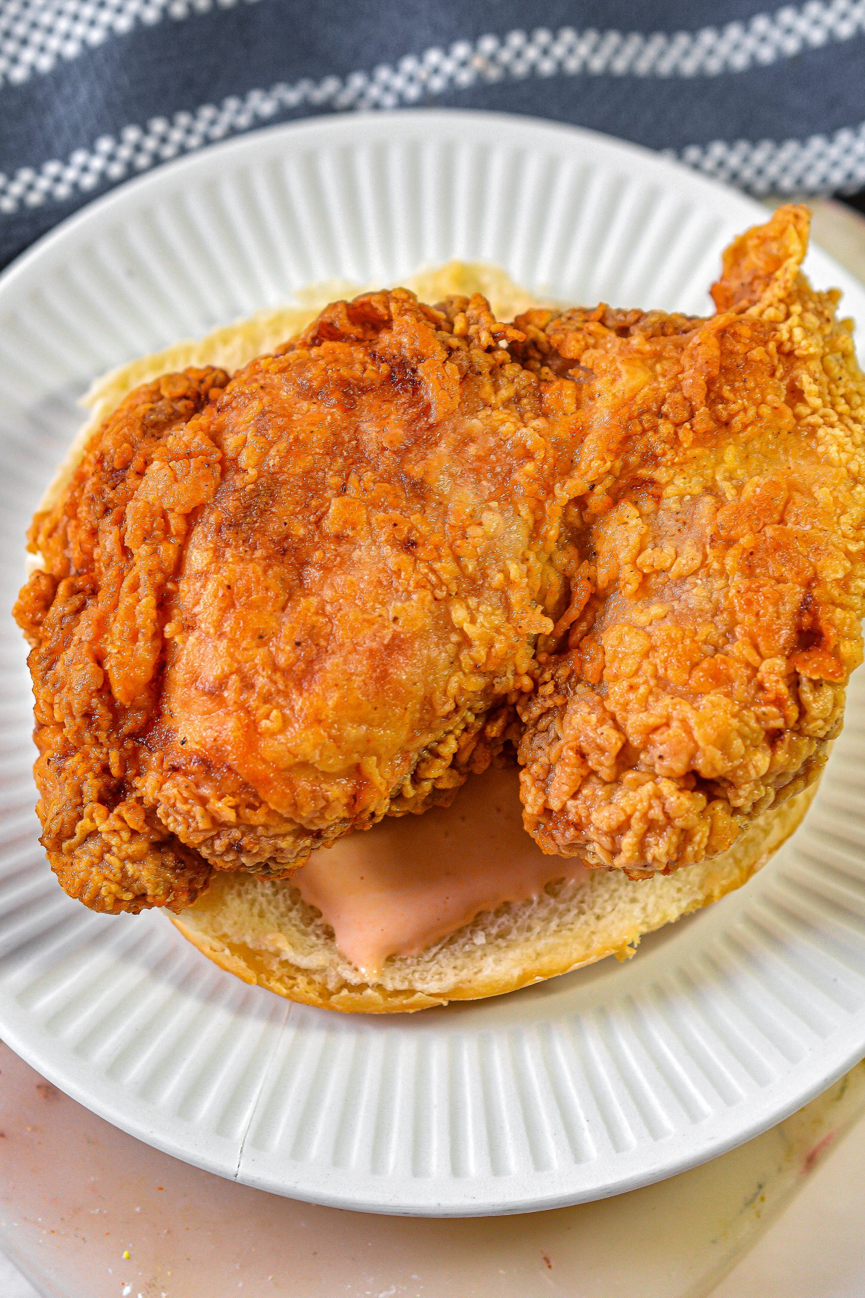 Place a piece of the fresh fried chicken on top.