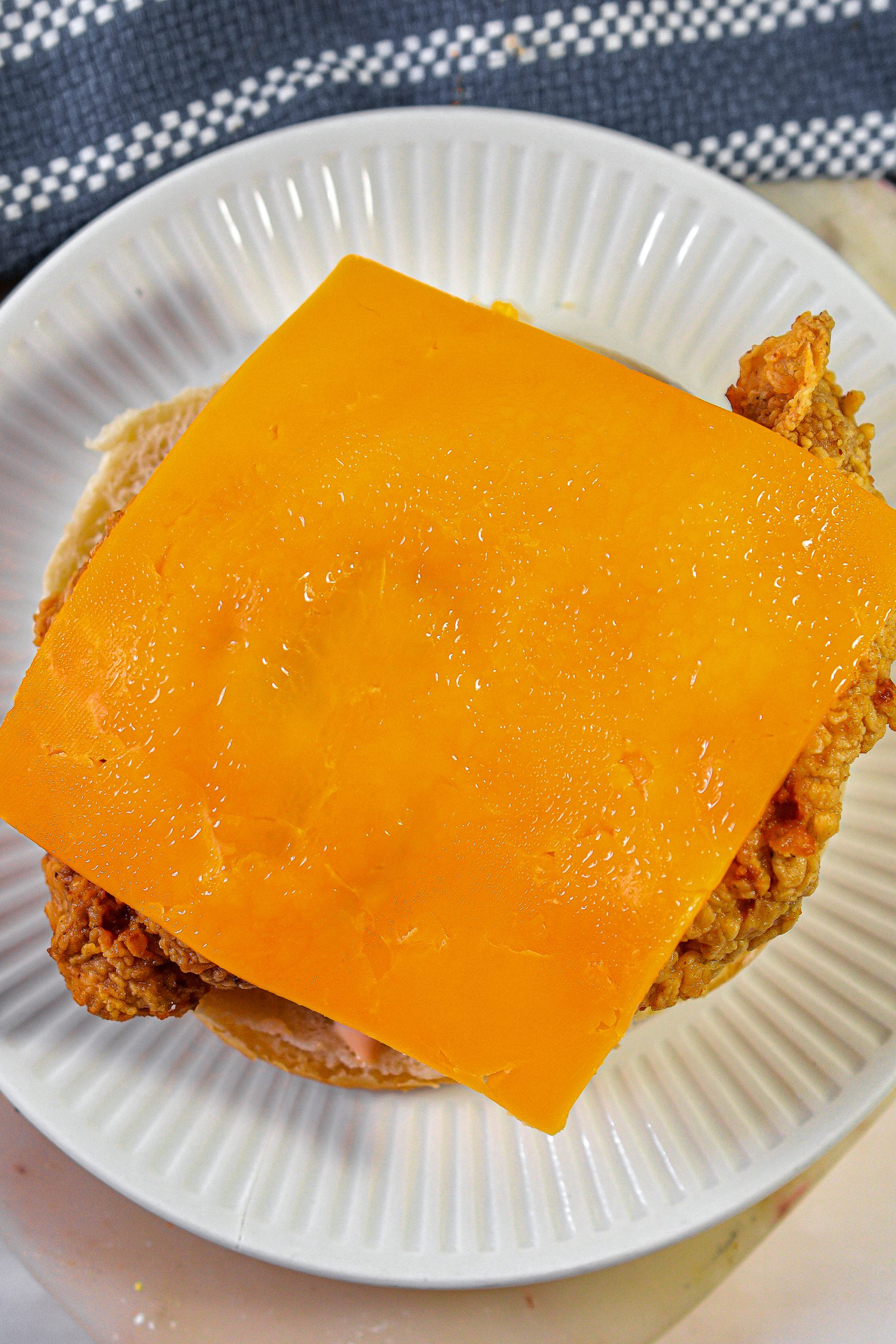 Top each piece of chicken with a slice of American cheese.